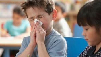 Student blowing nose