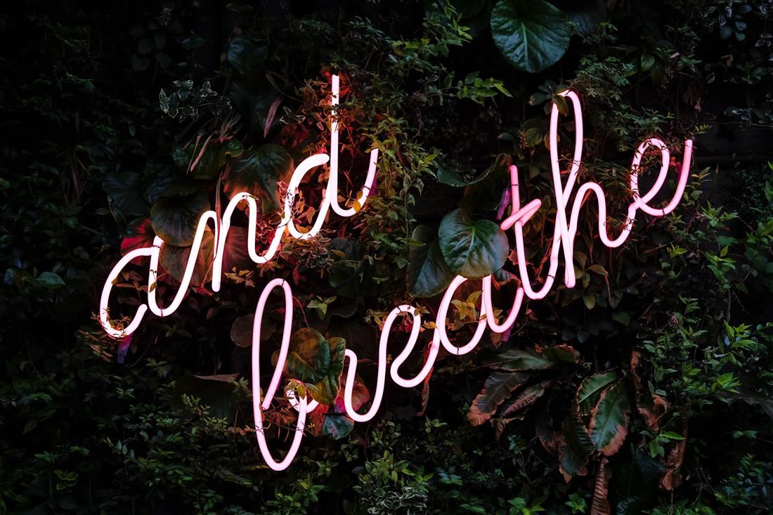 "And Breathe" neon sign