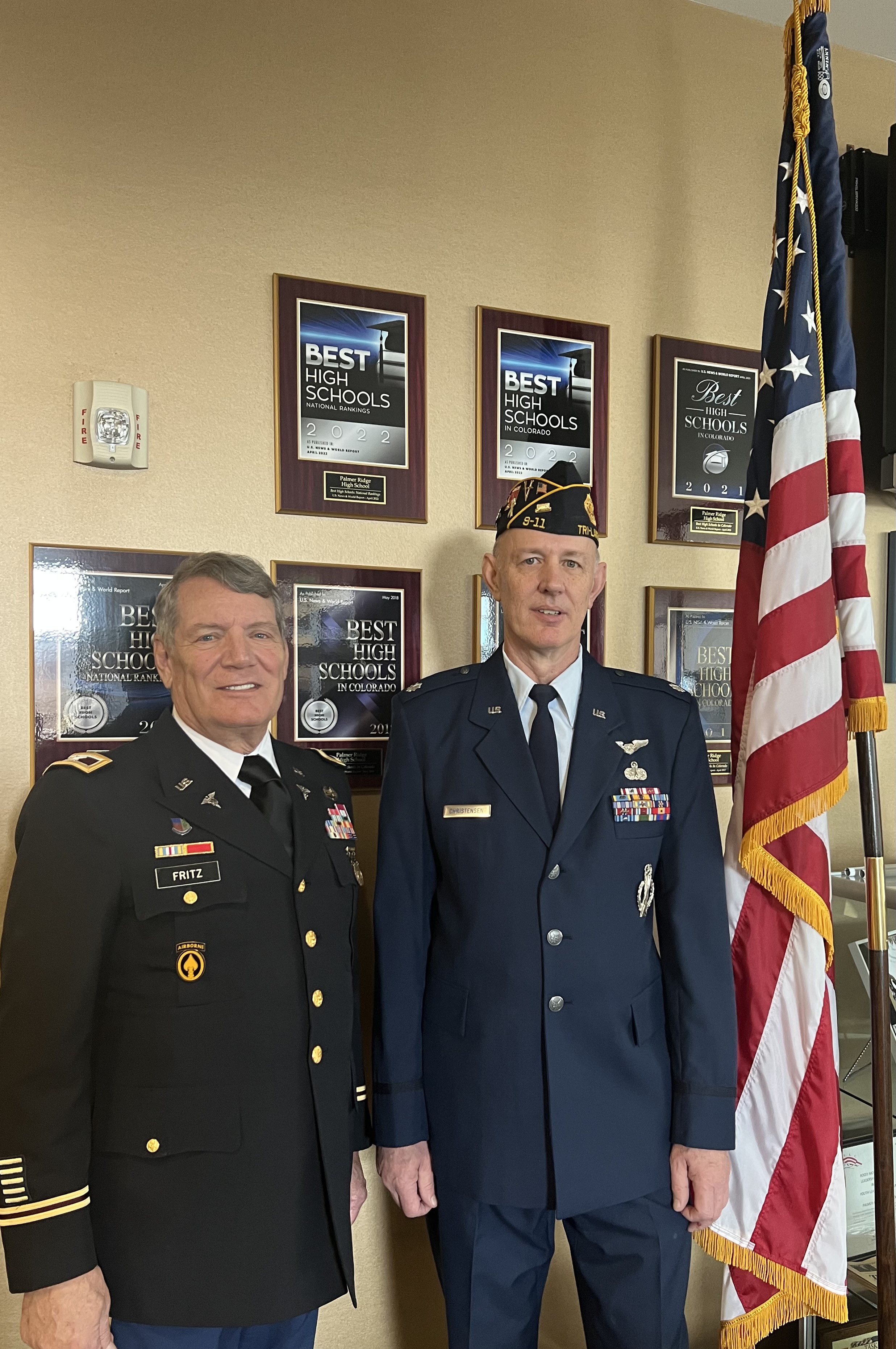 Veterans stand next to an American flag