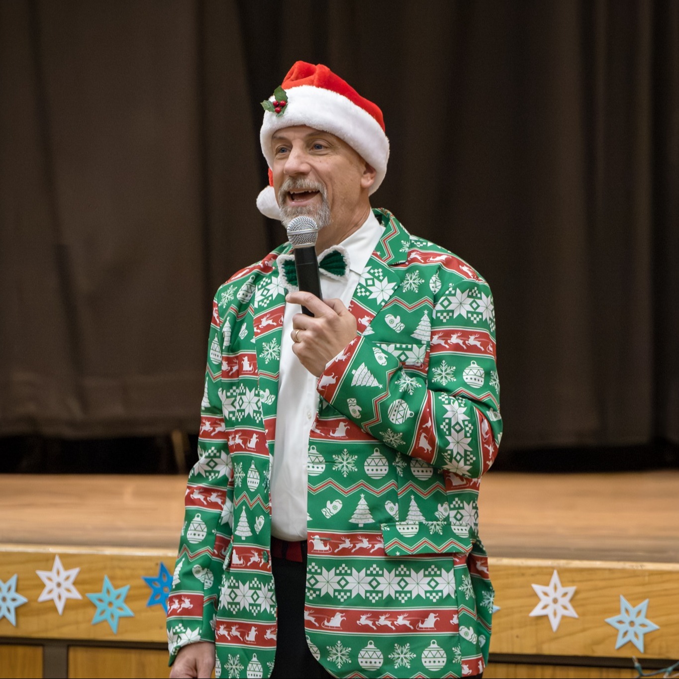 Kilmer Elementary Principal Greg Saunders dressed up in a Christmas hat and jacket