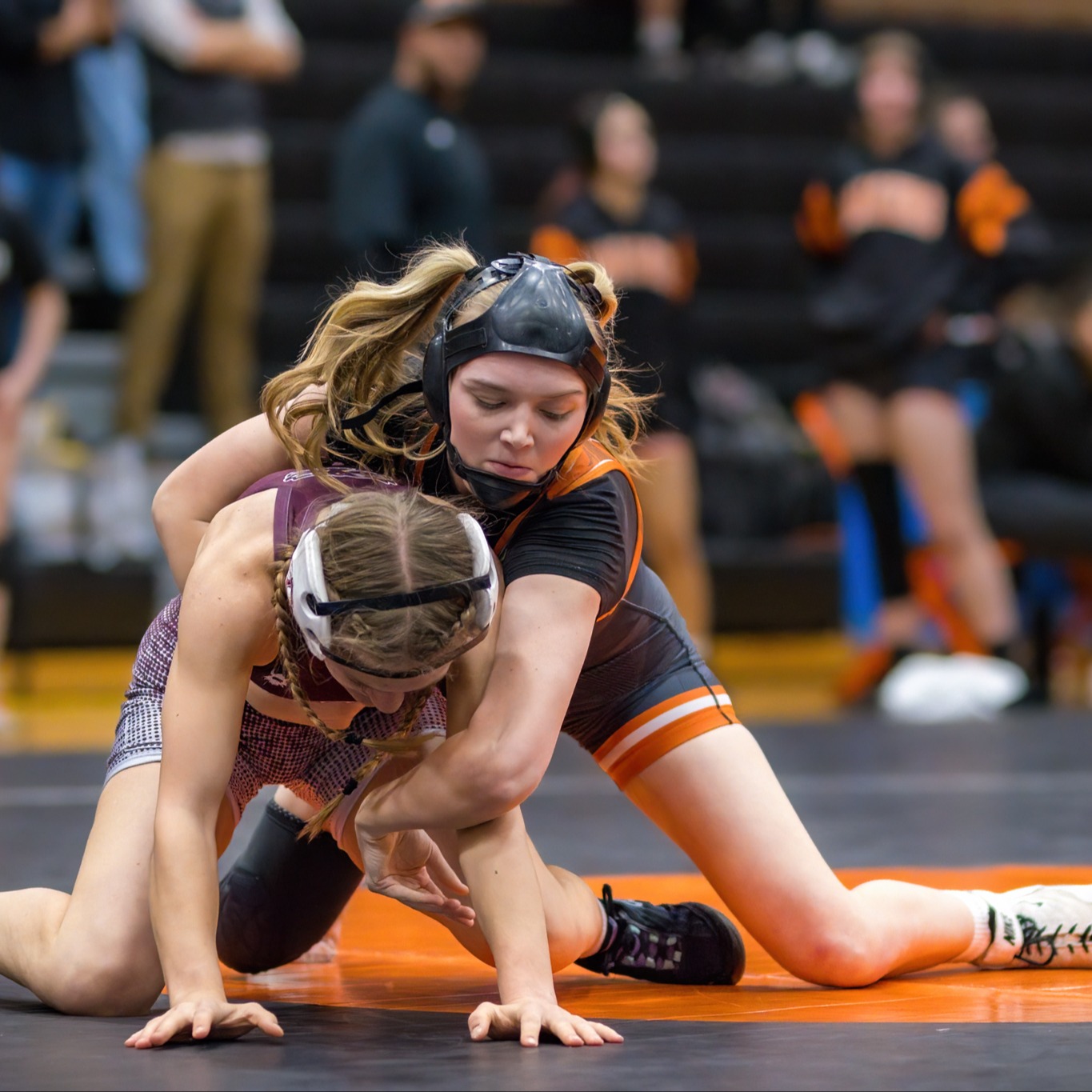 An LPHS Girls Wrestler takes control of an opponent during a wrestling match