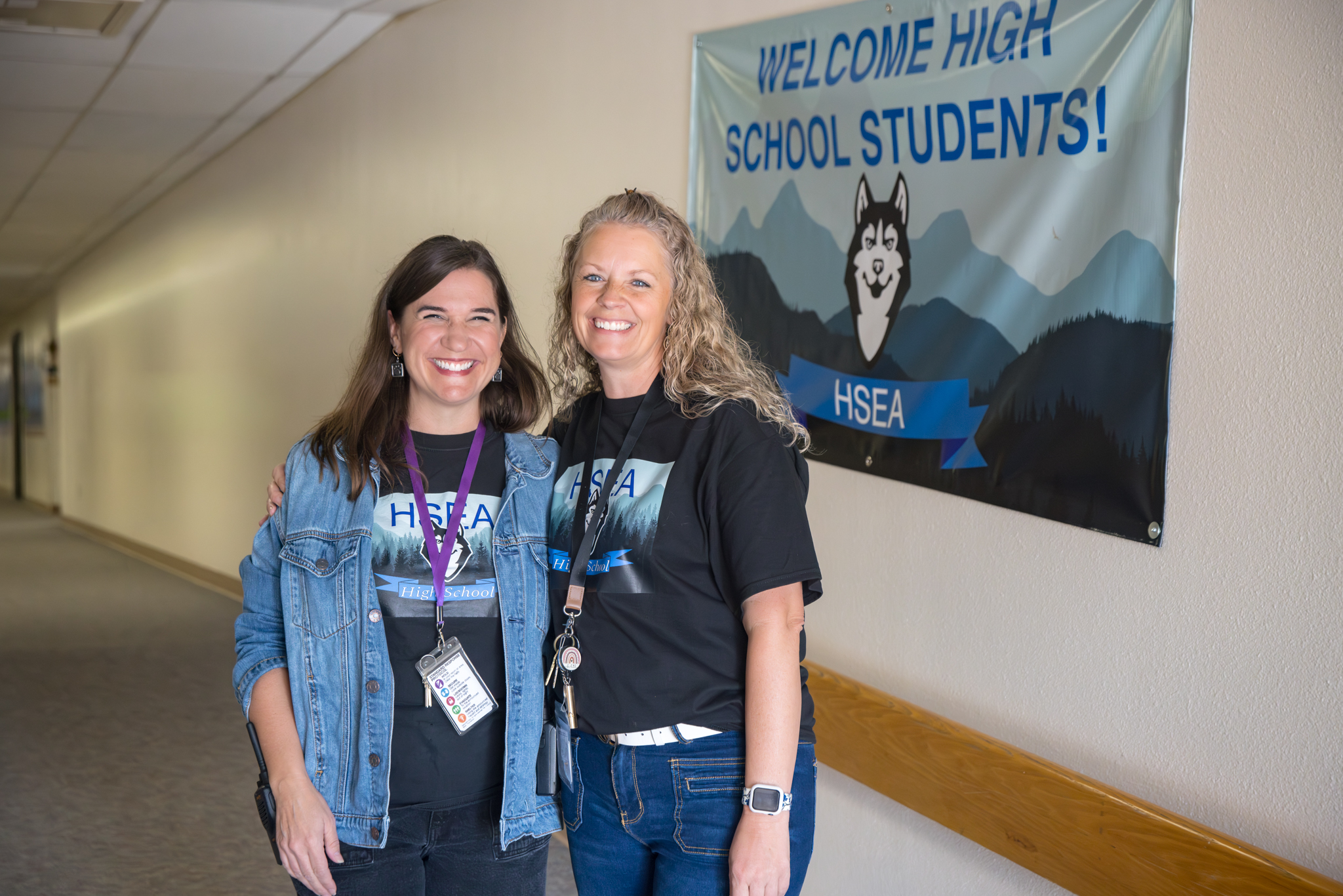 hsea techers standing in front of hsea banner