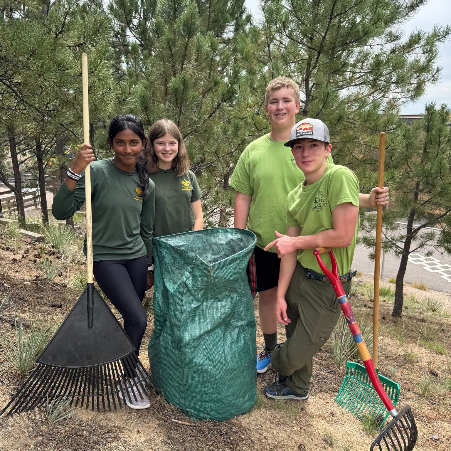 LPES students pose for a picture holding rakes and shovels