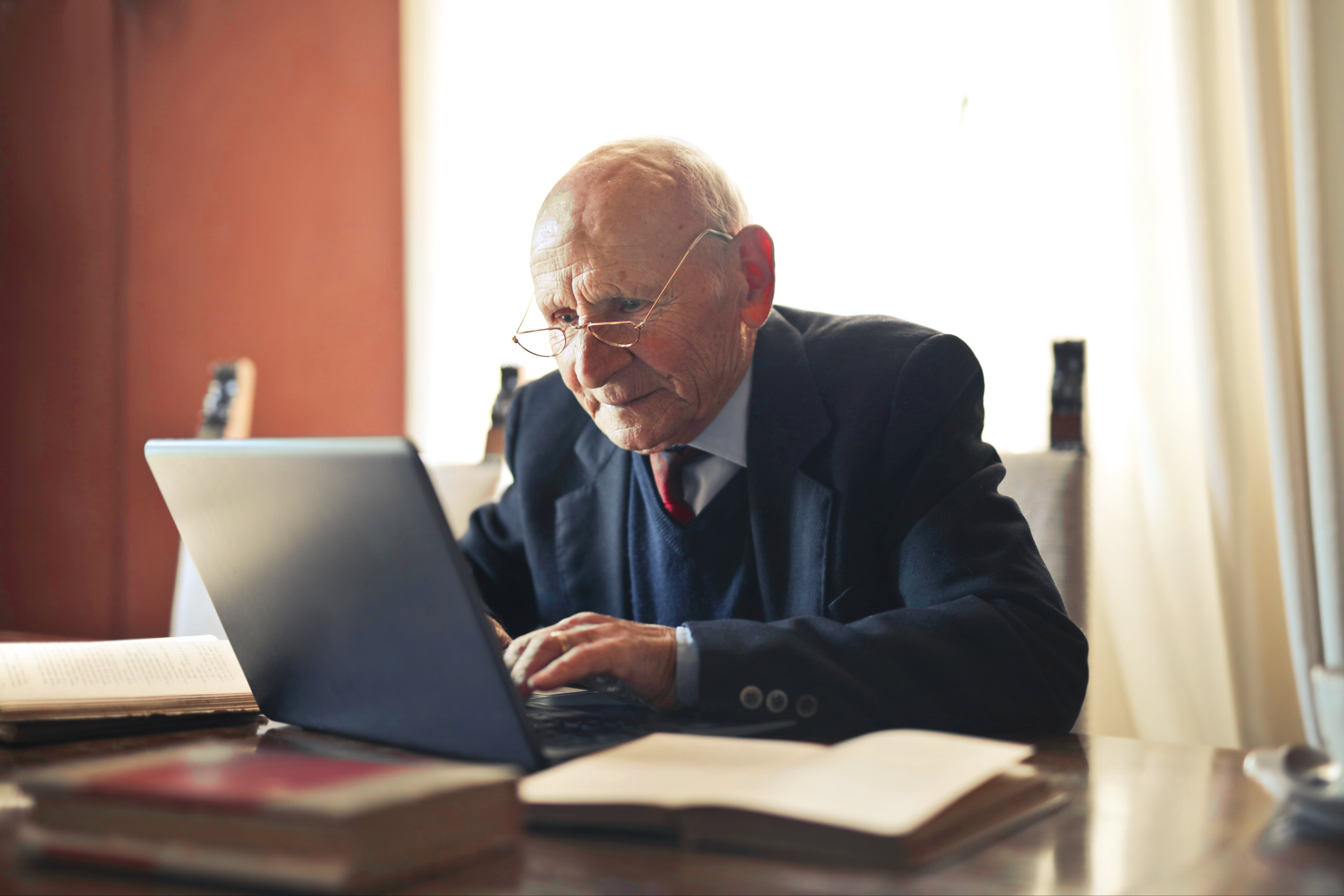 older man learning on laptop