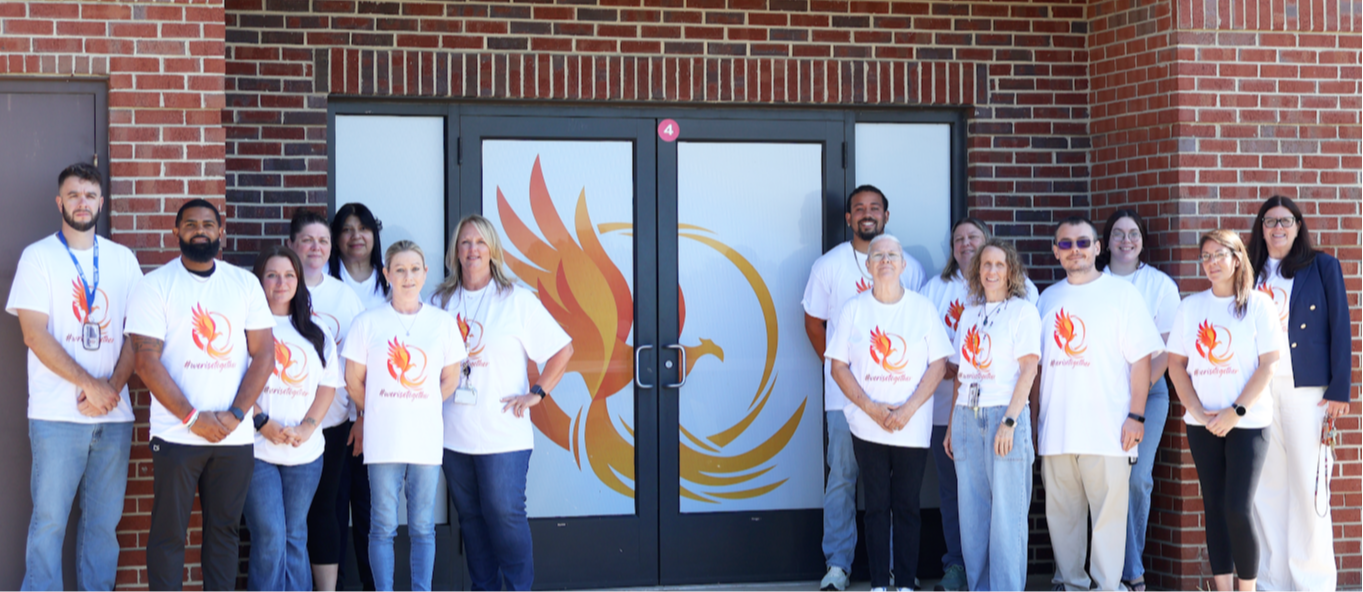 Our Phoenix Alternative Education Staff 2026-2027 Our 26/27 staff sporting their new phoenix gear! left side Mr. Joshua Hemperly, Mr. Mark Dennis,  Mrs. Samantha Broyles, Mrs. Reachel Wolf,  Mrs. Sonja Gray,  Ms. Melissa Boxley,  Mrs. Kelly Richardson. On the right side back row Mr. Dai Jordan Brown, Alison Crane, Briana Abeijon, On the Right side front row, Ms. Maureen “Moe’  Bough, Jennife Perdue, Mr. Dylan Dwyer, Ms. Desiree Babbitt, Mrs. Kimberly Watts.