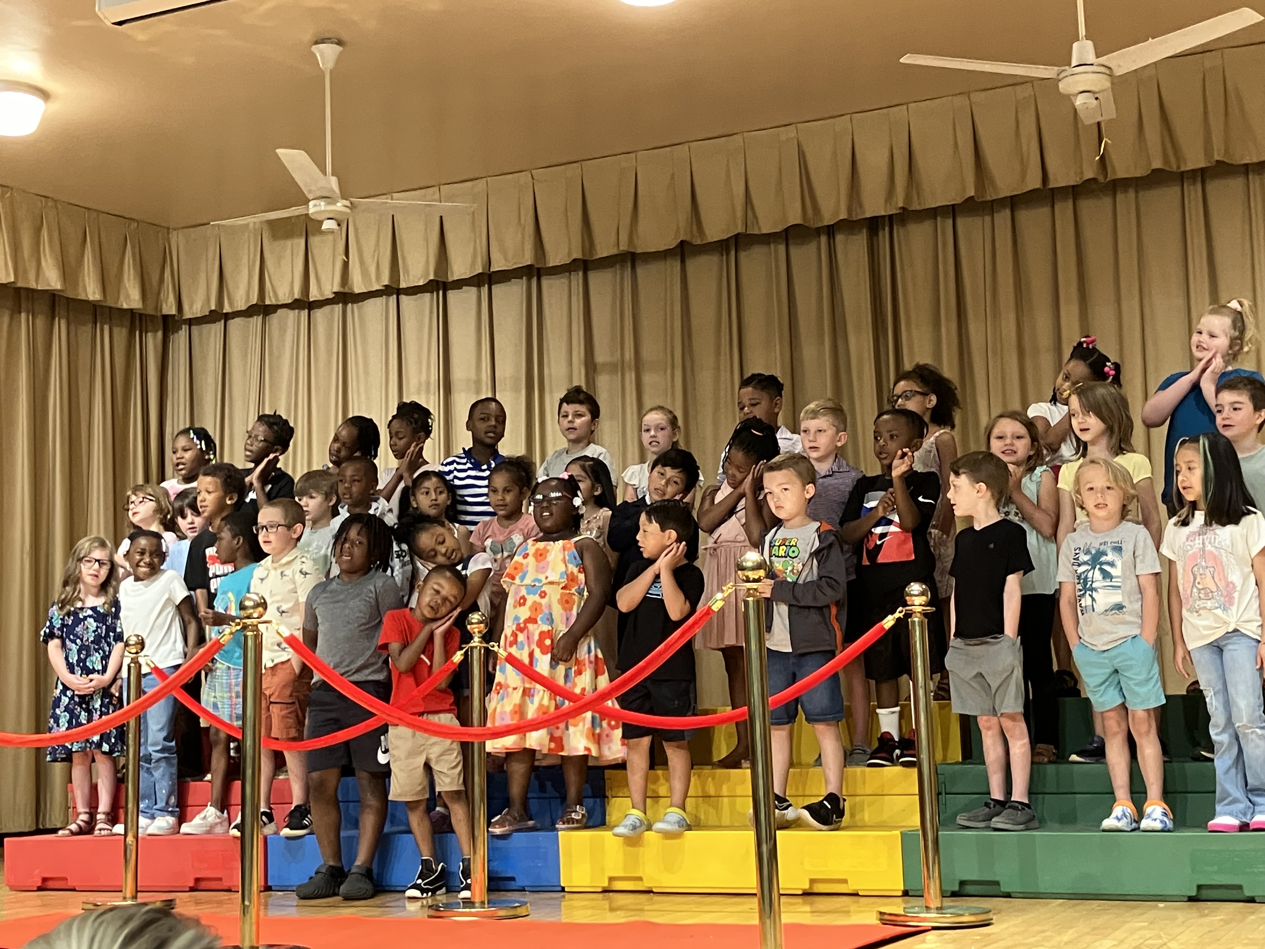 Students standing on stage for end of the year program.