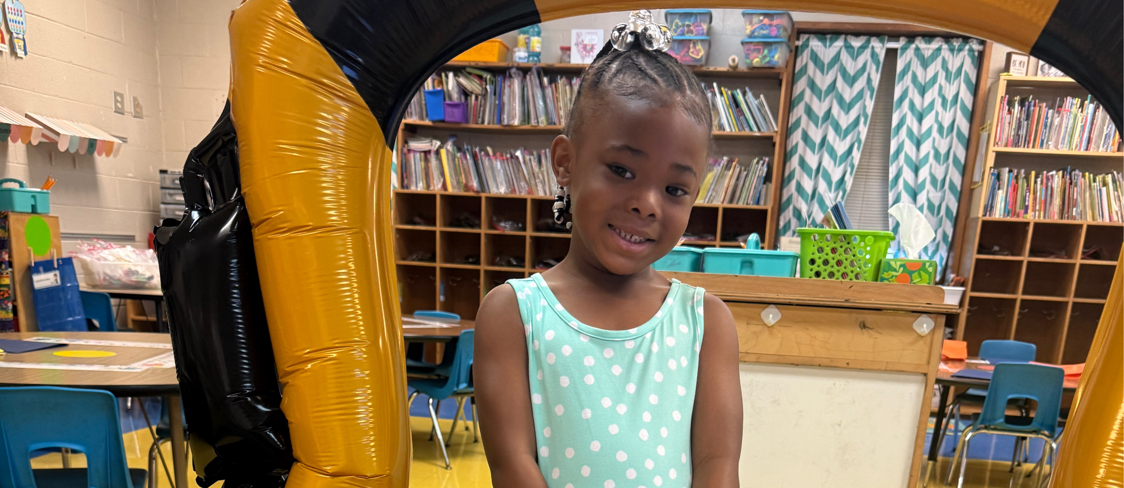 Student posing for a back to school picture.