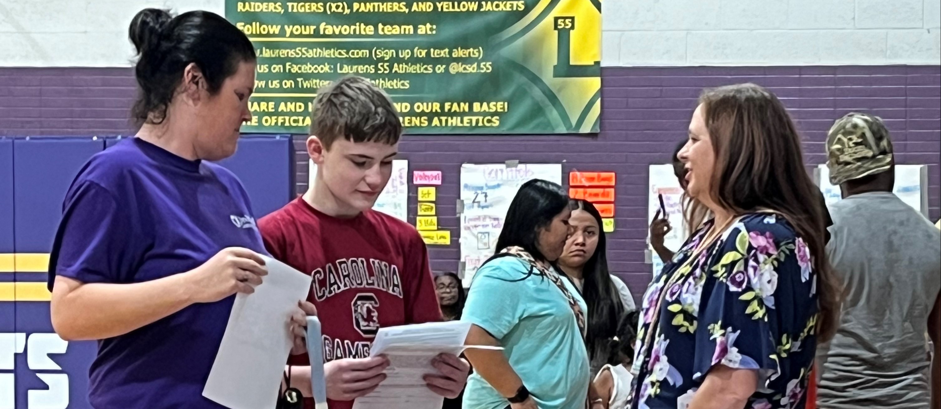 Color  photo of librarian with parent and student