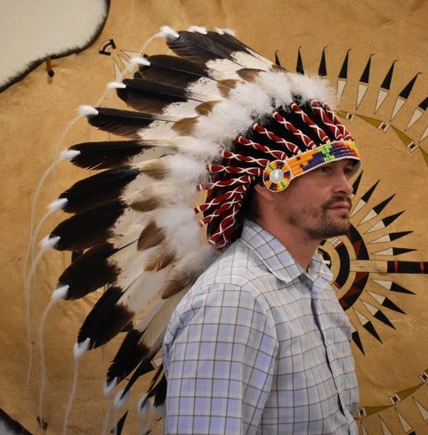 Man wearing an  American Tribal Traditional Headdress