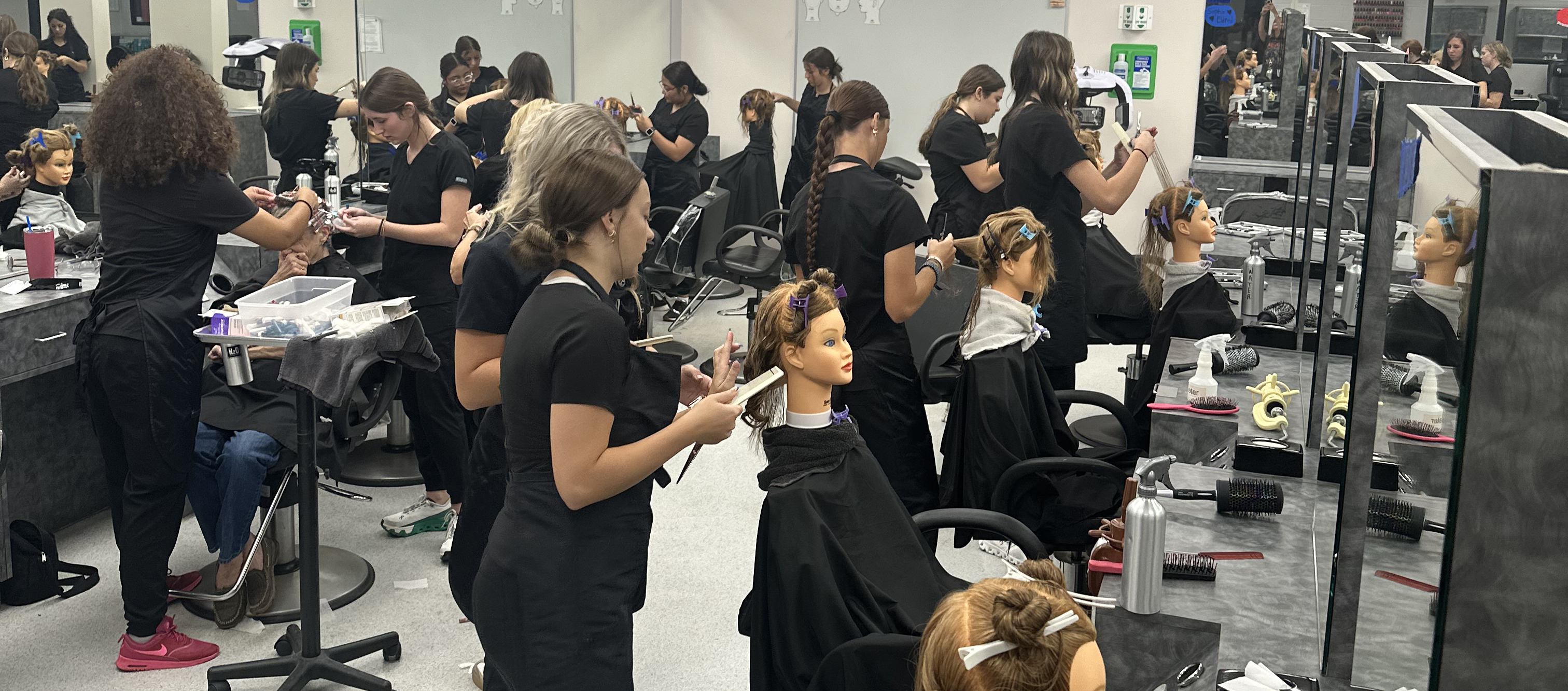 Students in the cosmetology student salon area