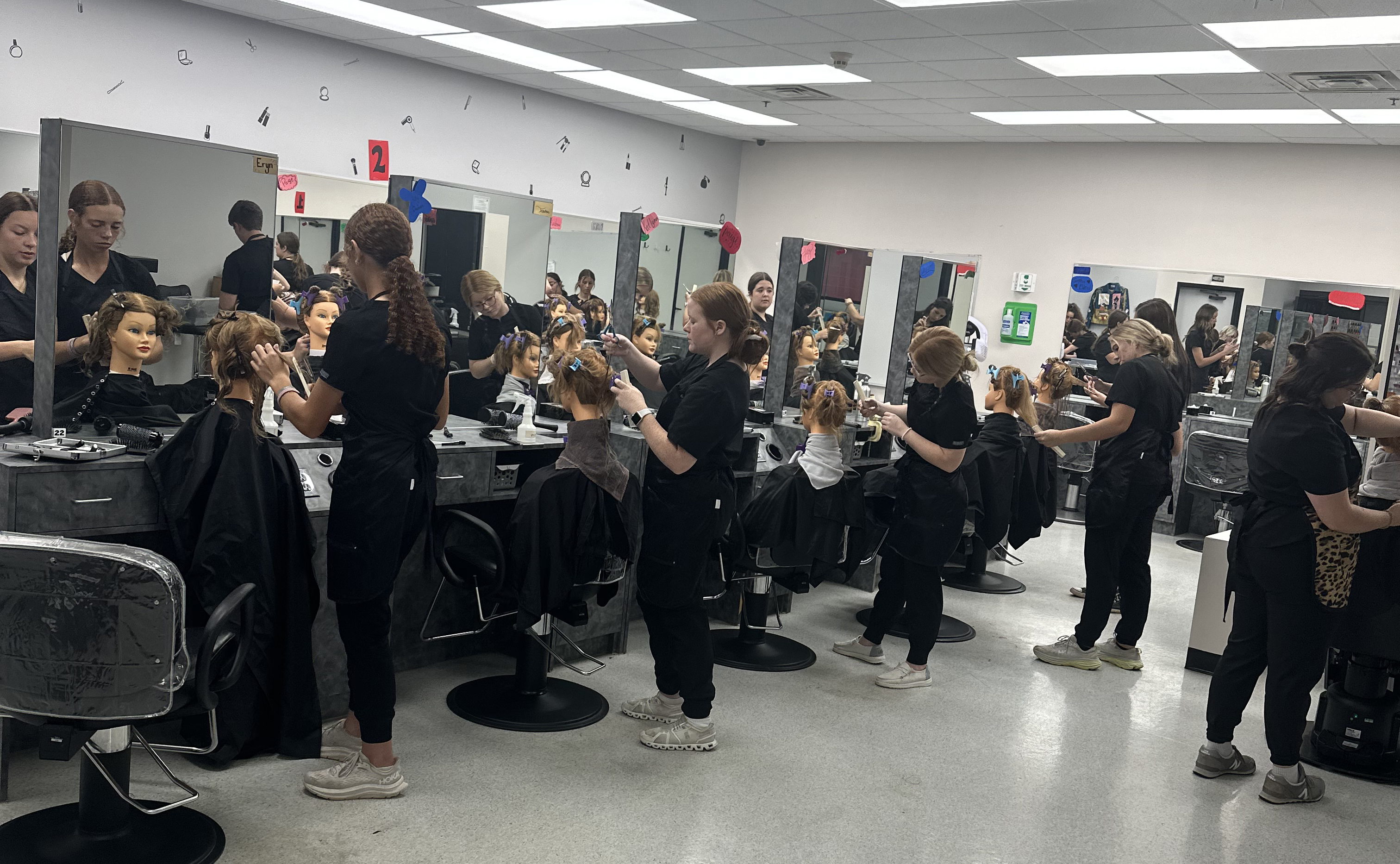 Students in the cosmetology student salon area