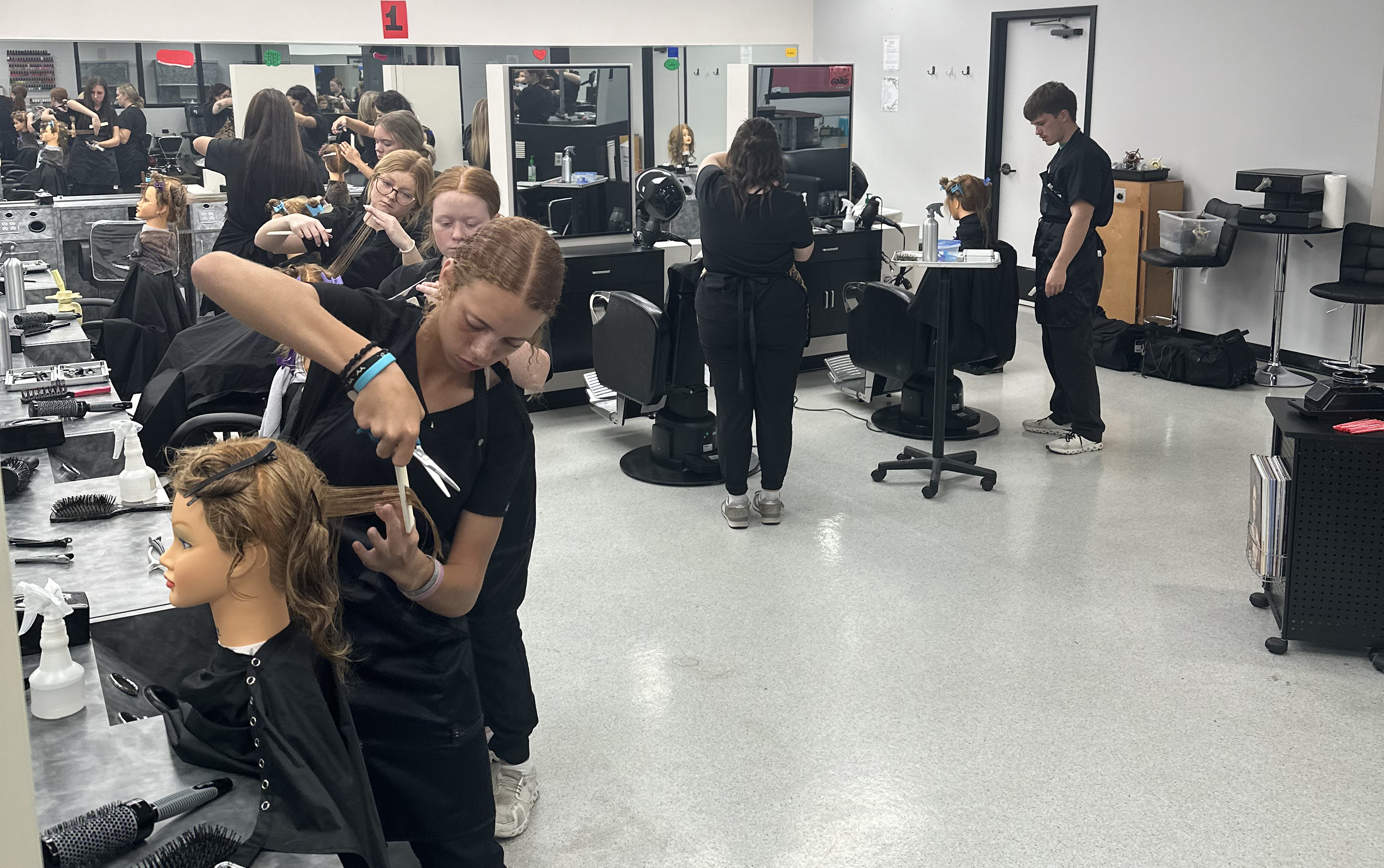 Students in the cosmetology student salon area