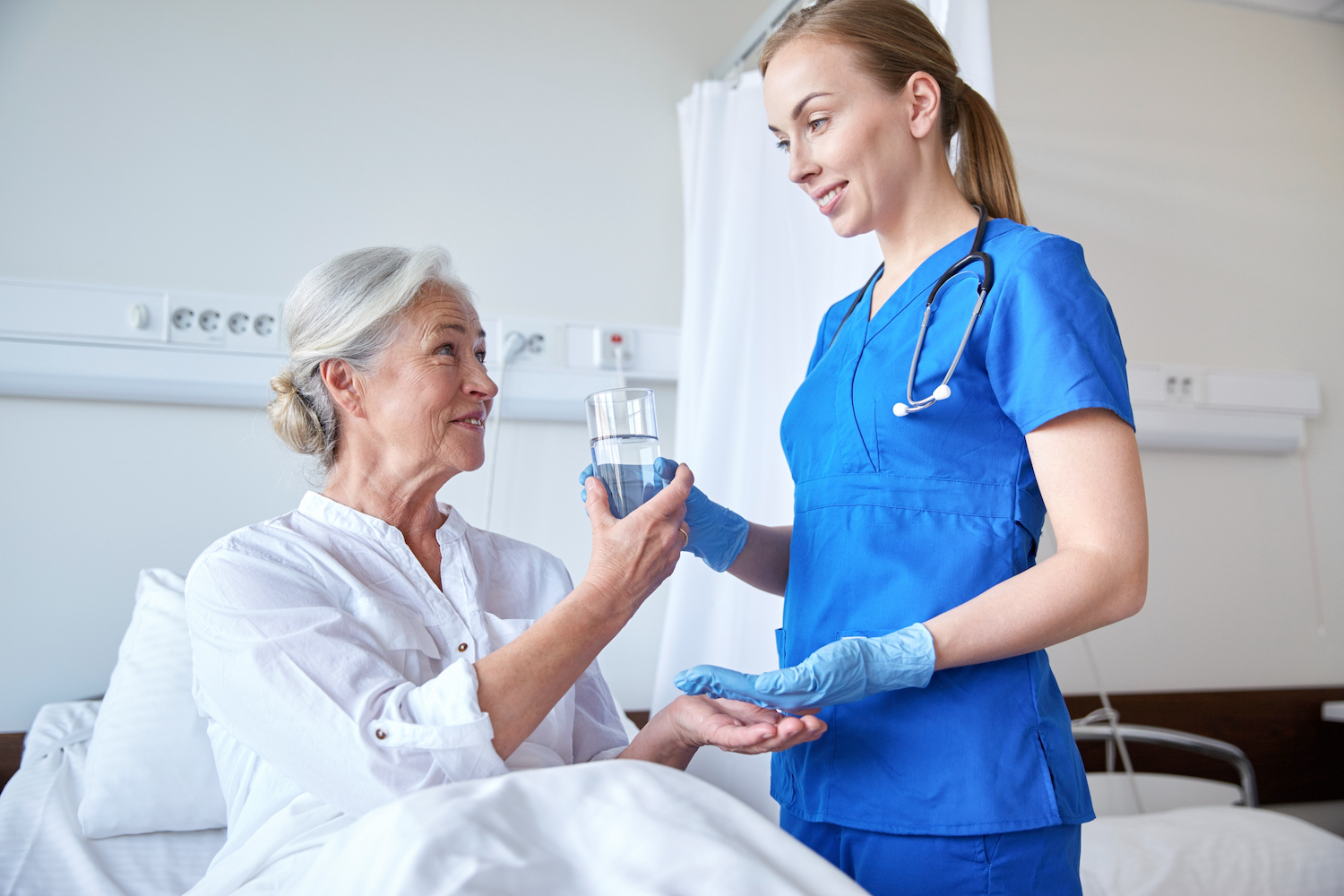 Picture of a nurse giving patient some medications