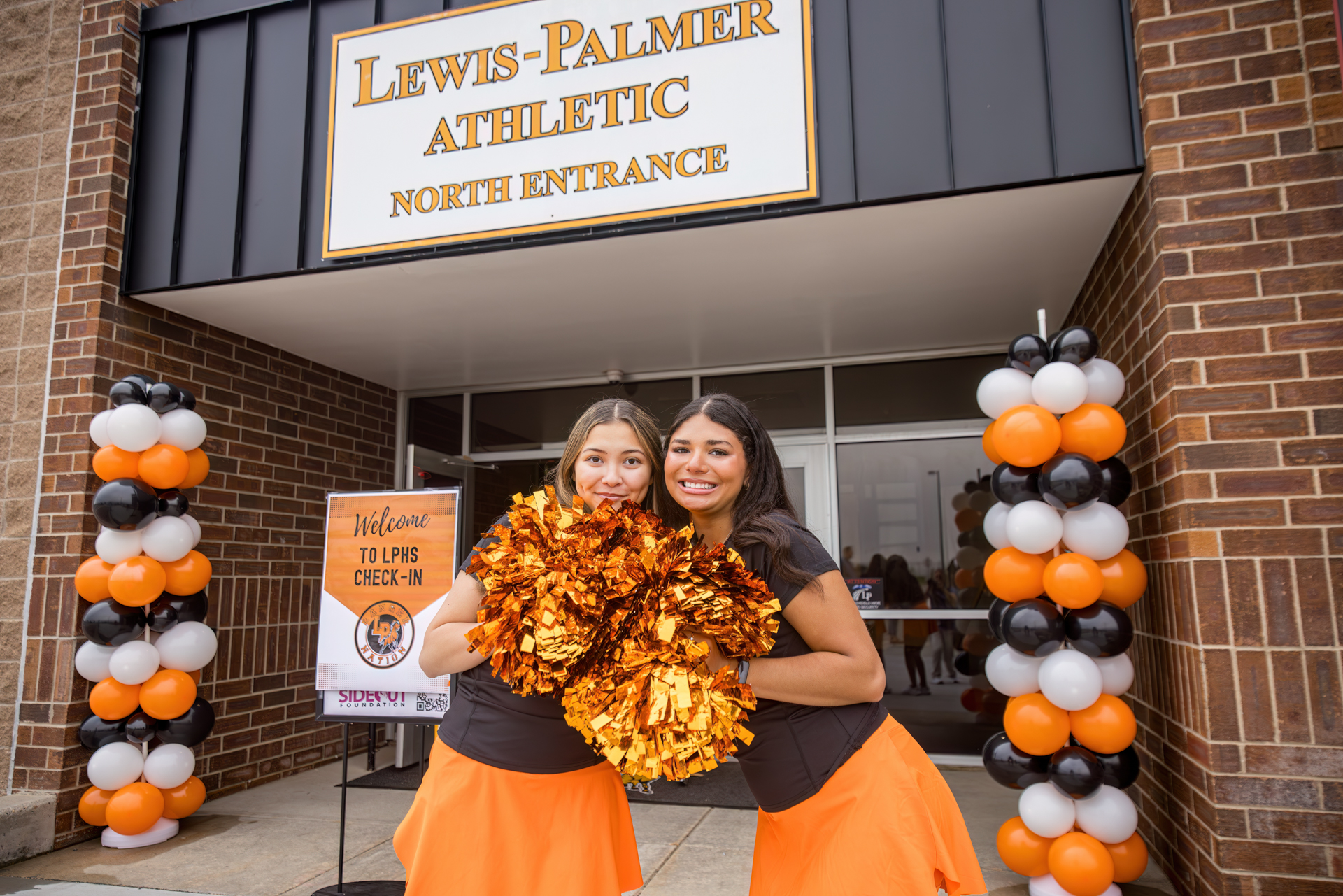 Cheerleaders at entrance with pompoms