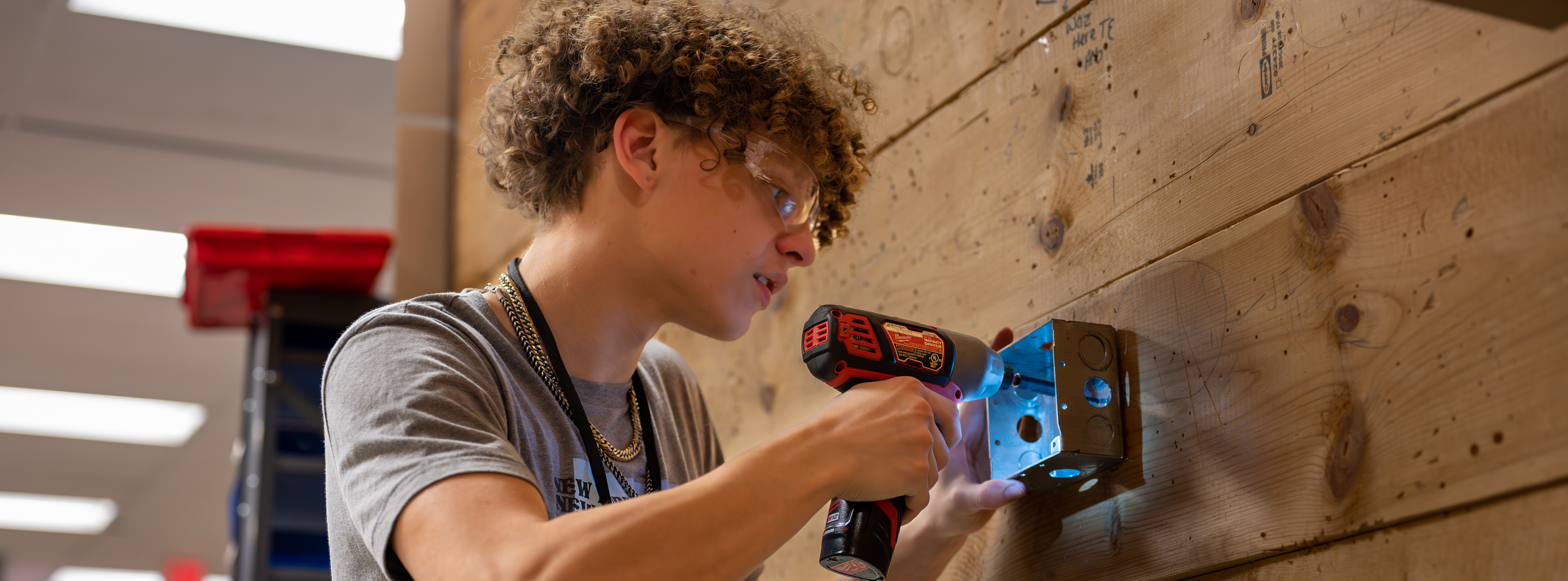 Student with an electric drill
