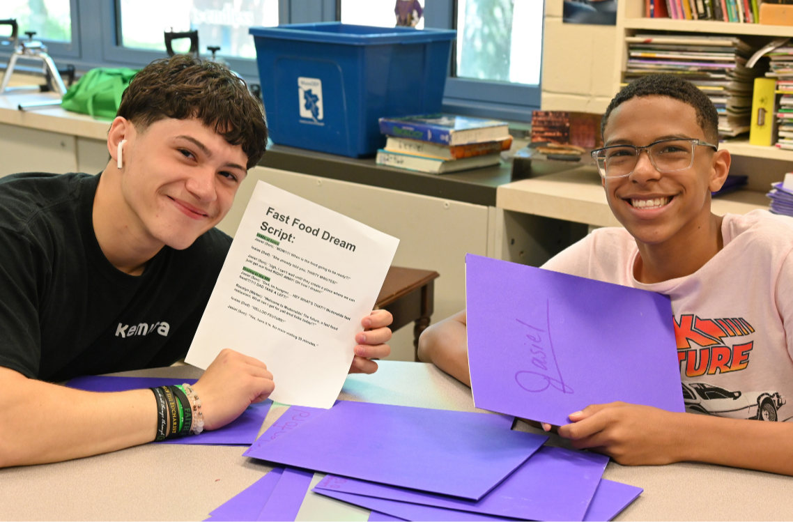 Two students from the Performing Arts academy show their script for "Fast Food Dream," an arts-based approach to learning health and science