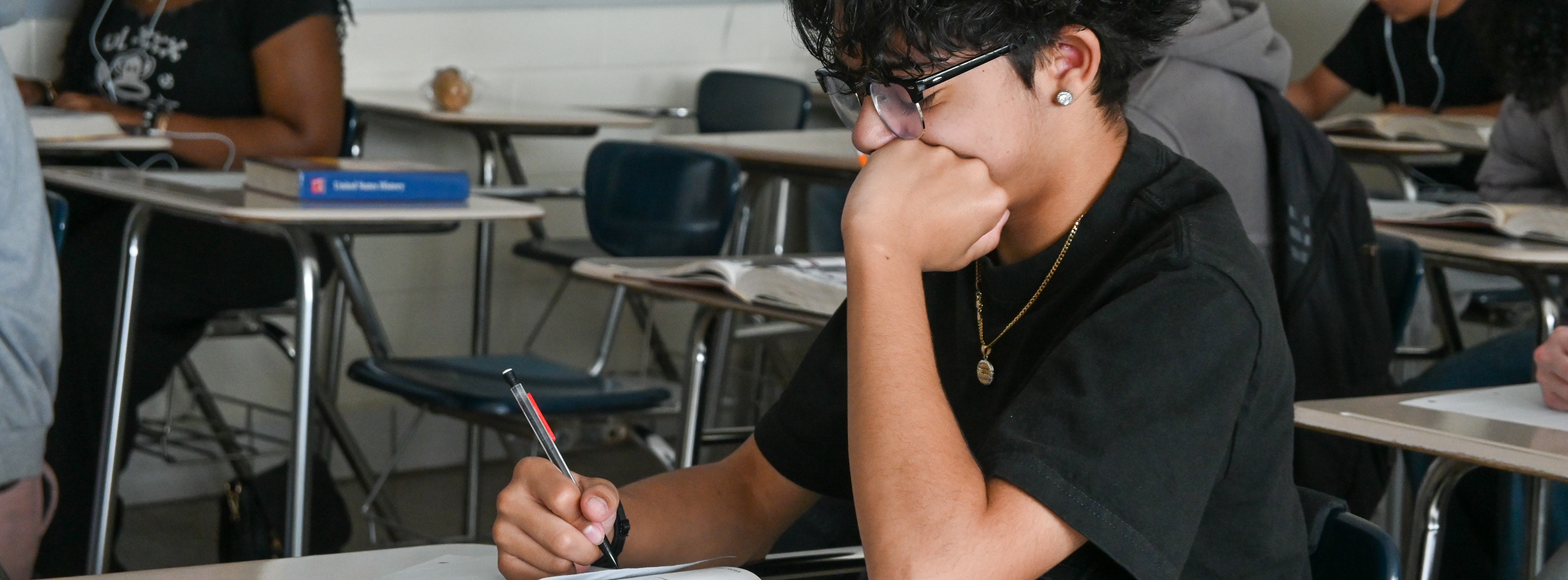 student working on an assignment at desk
