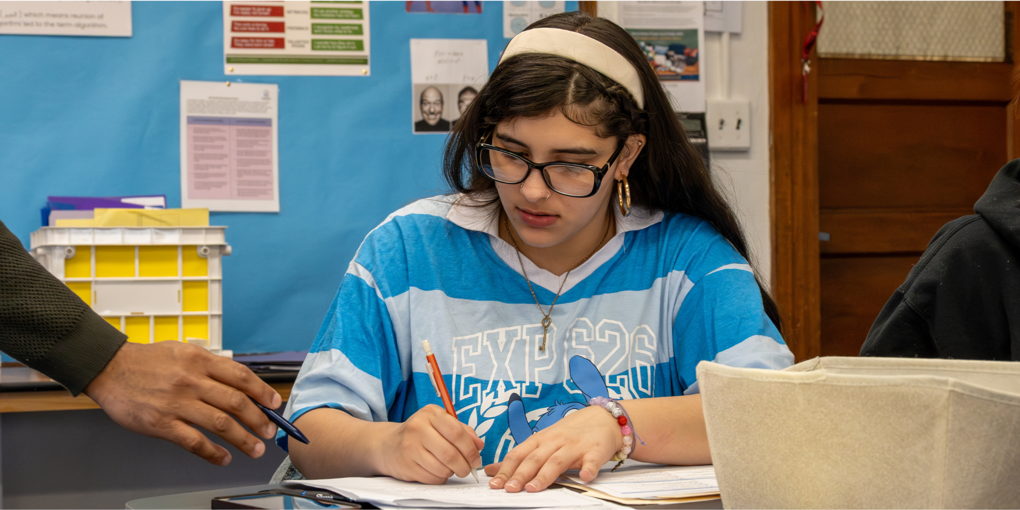 student writing on an assignment
