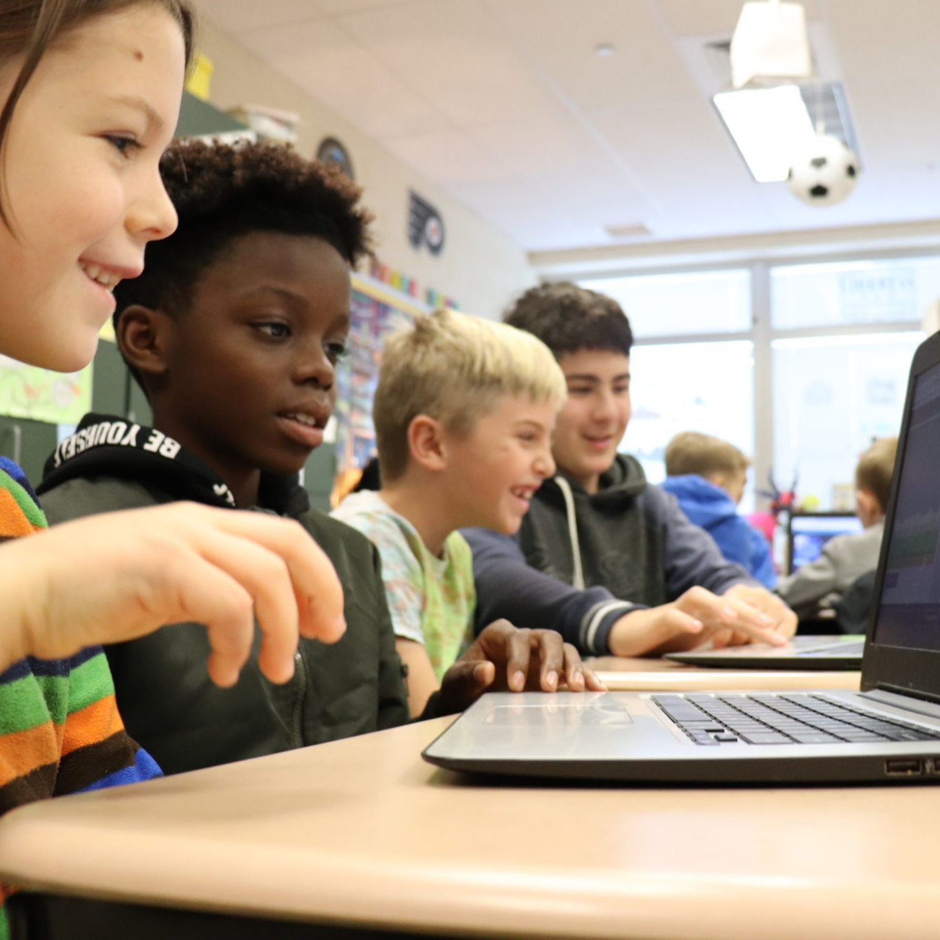 Young students working on a laptop