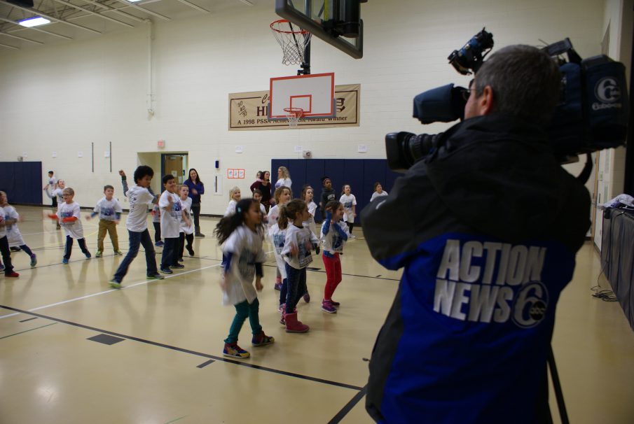 A camera man filming a gym class