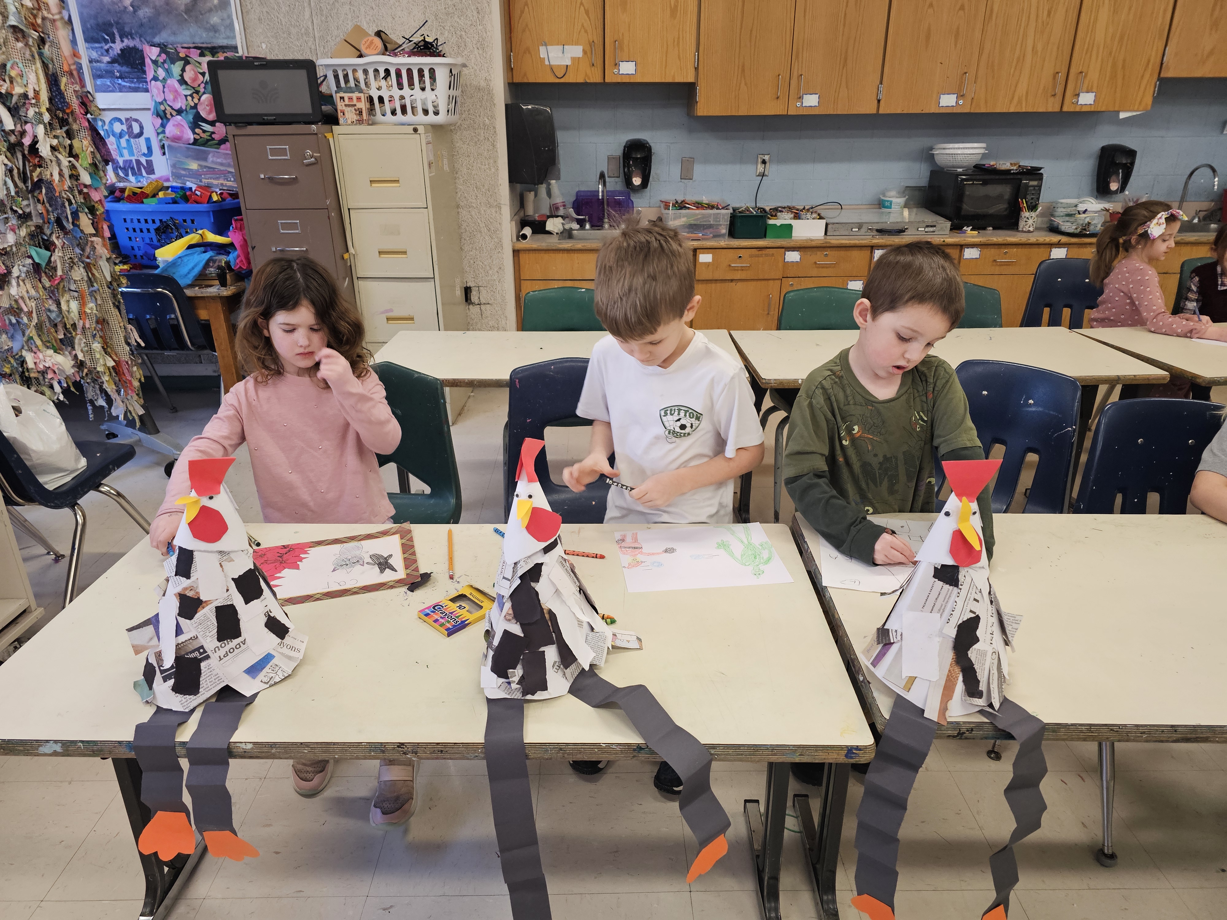 Kindergarteners working on chicken sculptures