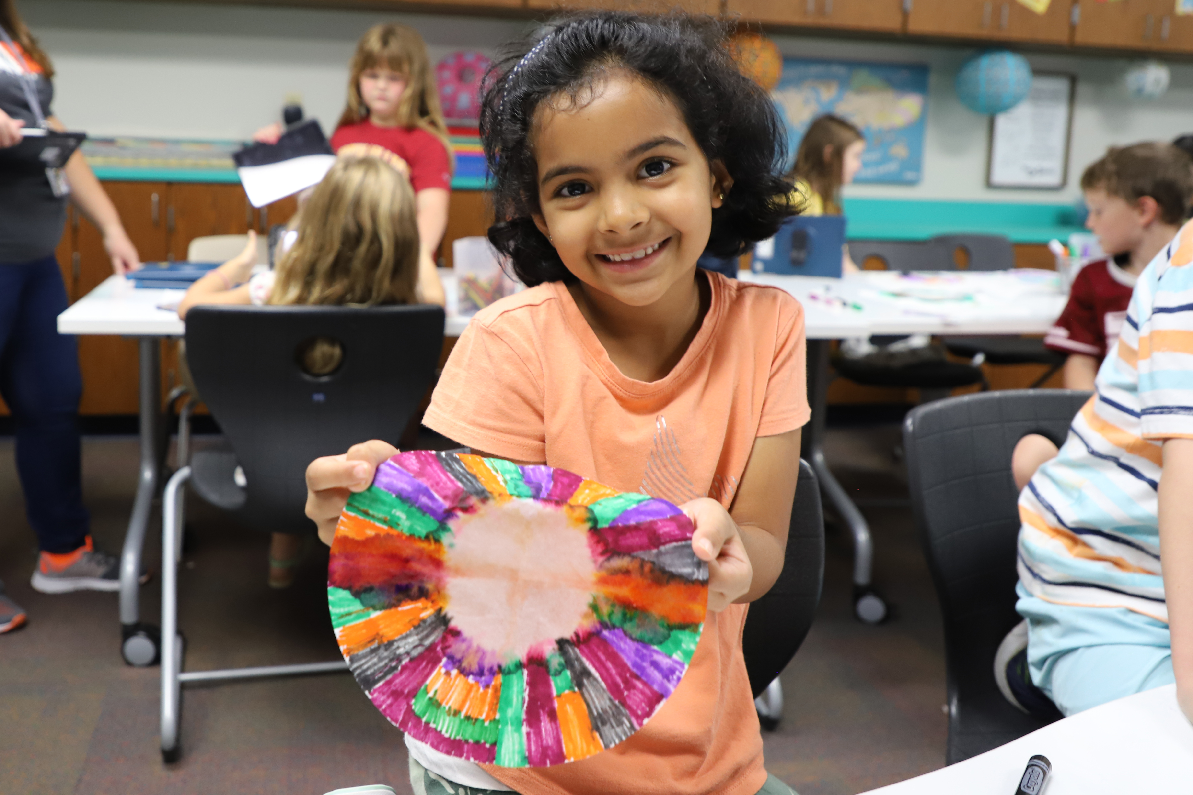 Monckingbird Elementary student excited about her art work.