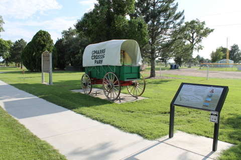 A part with a covered wagon display and an informational sign