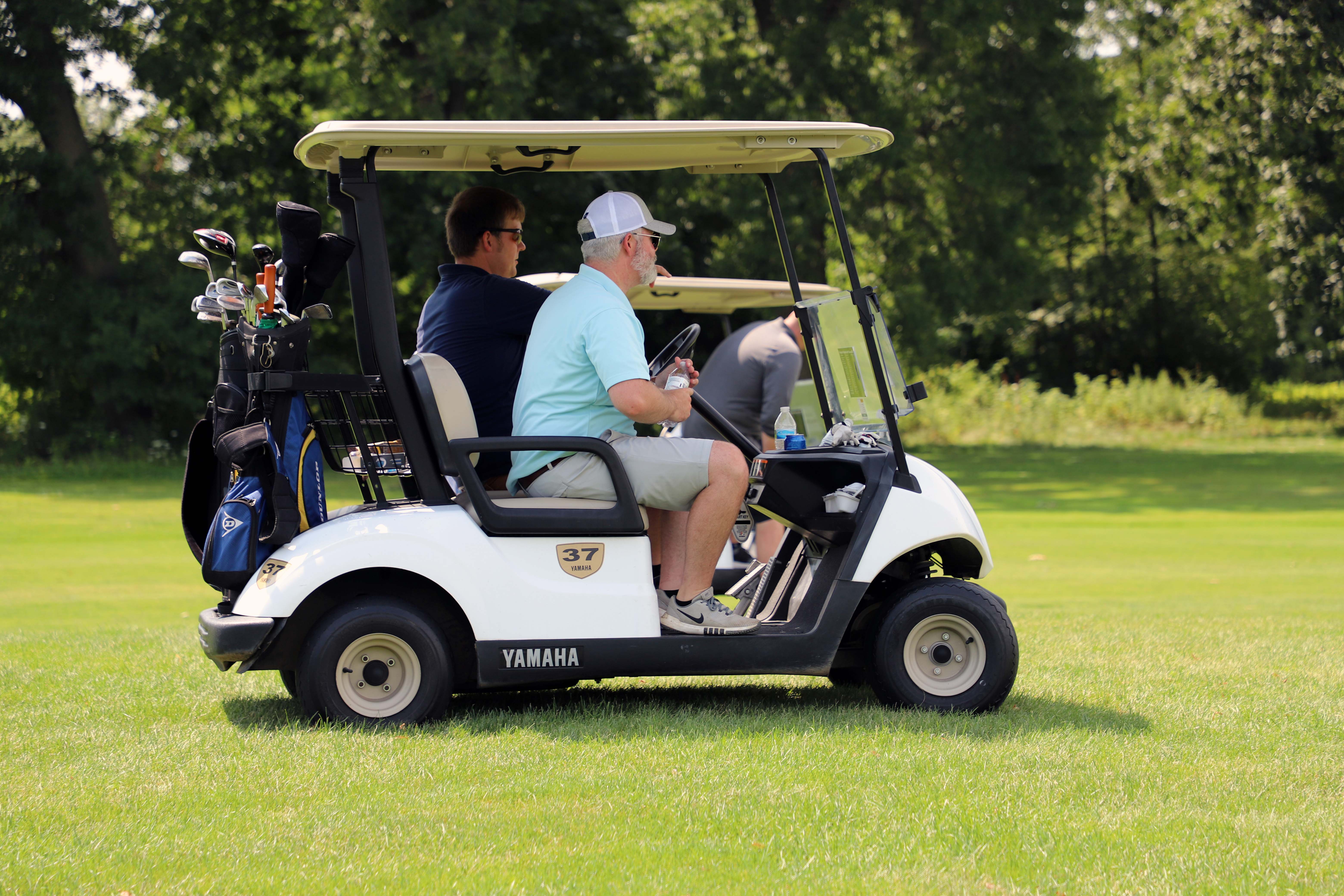 golf cart and golfers