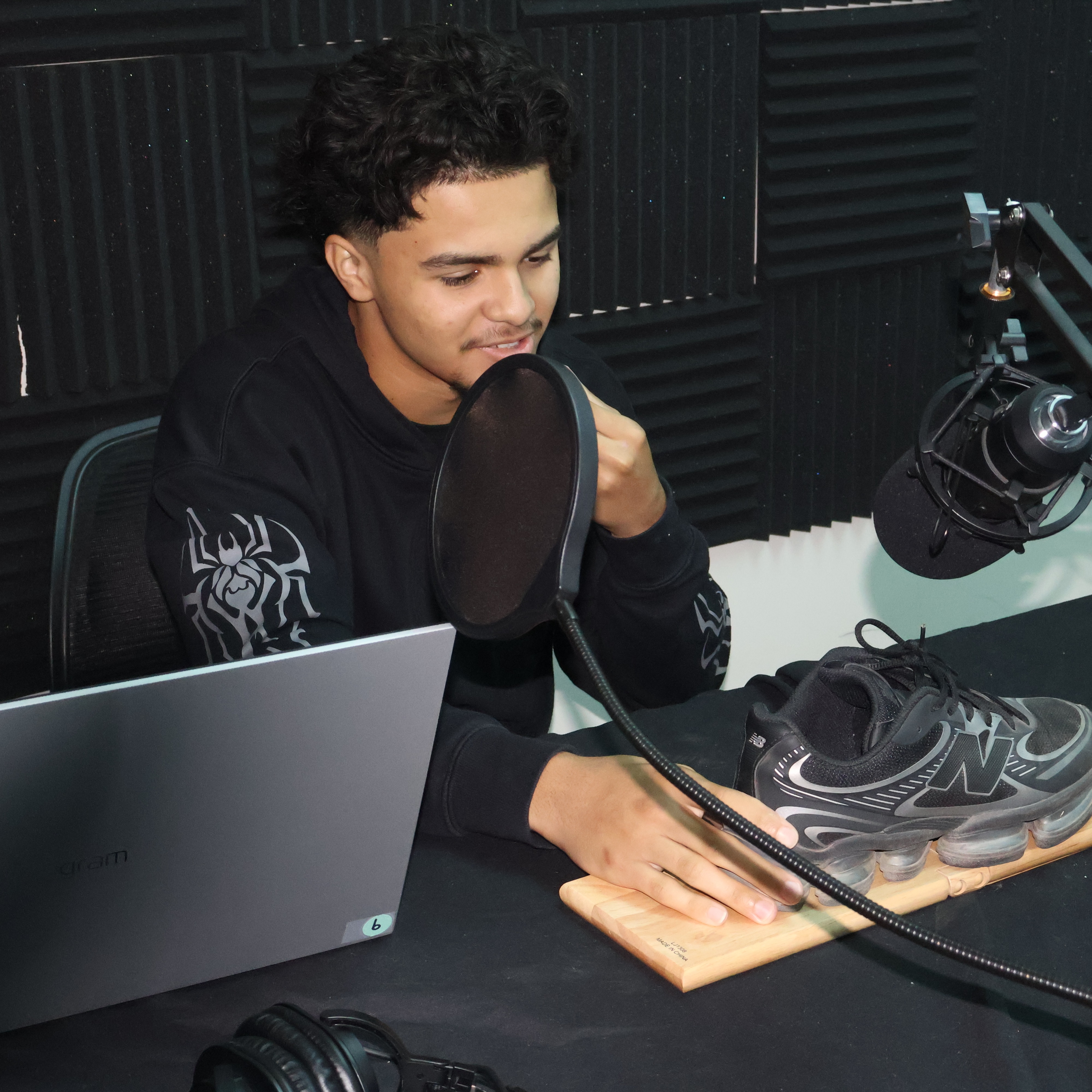 Multimedia student recording foley sound to accompany an animated short