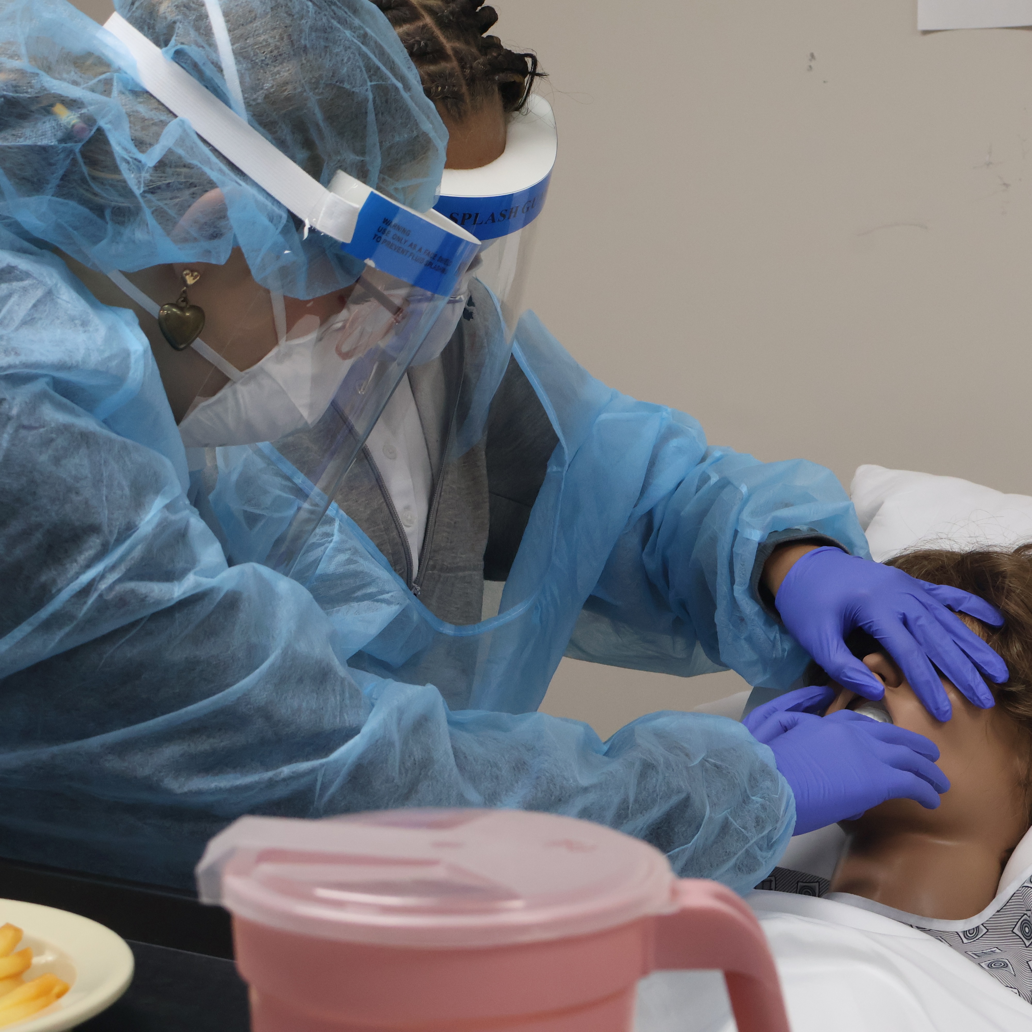 HS students in PPE demonstrating patient care
