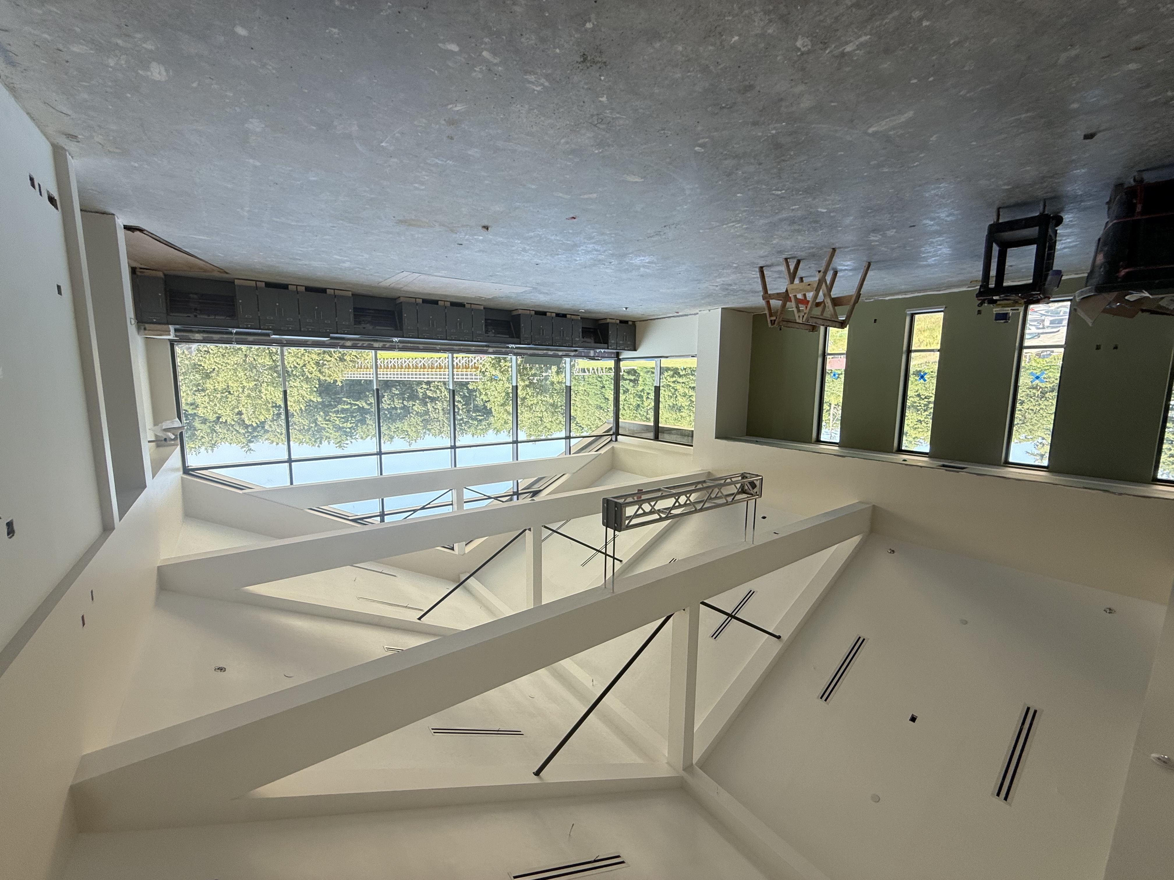 Vaulted ceilings and a large window in an unfinished science lab.