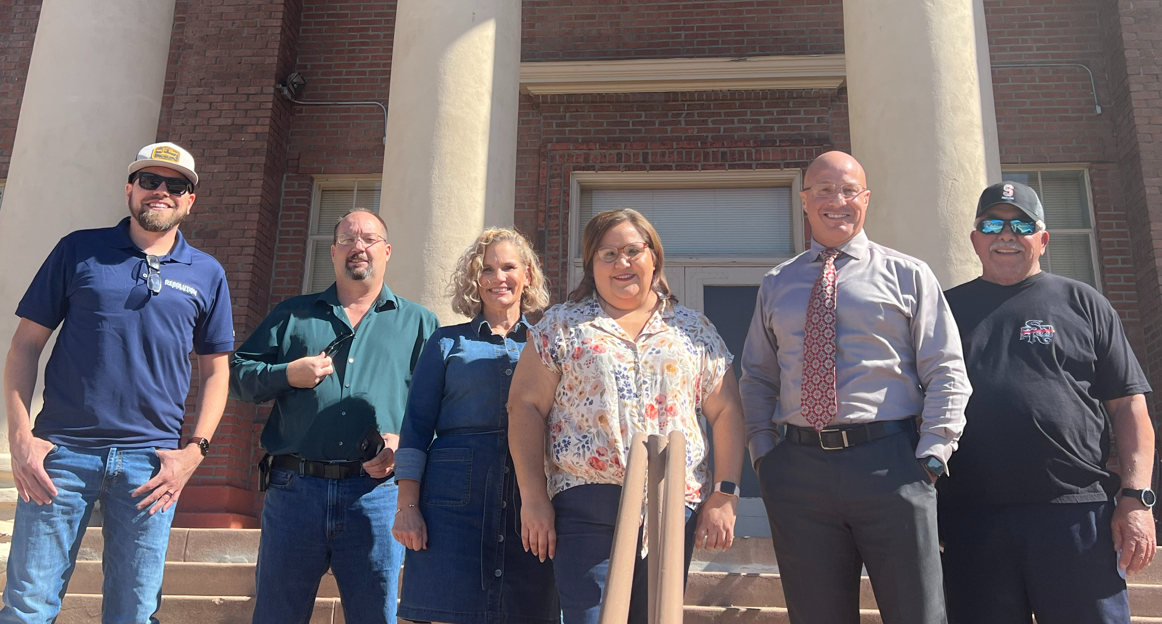 Six CVIT partners standing in front of historic building