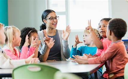 female working with students in classroom