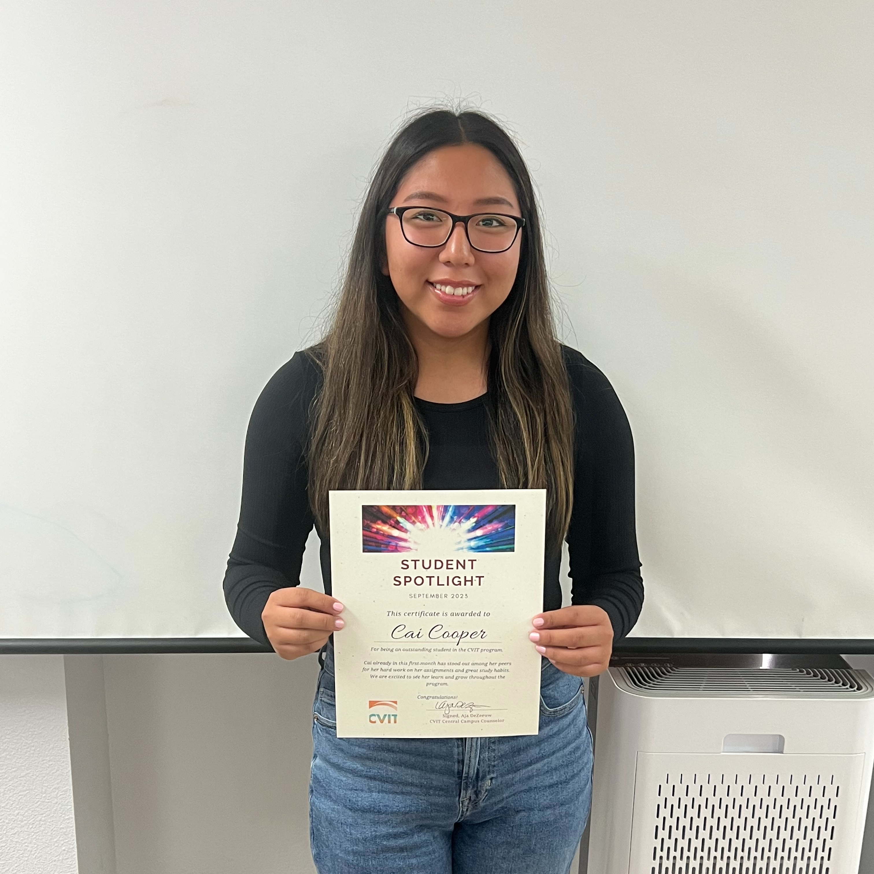 Female student holding certificate