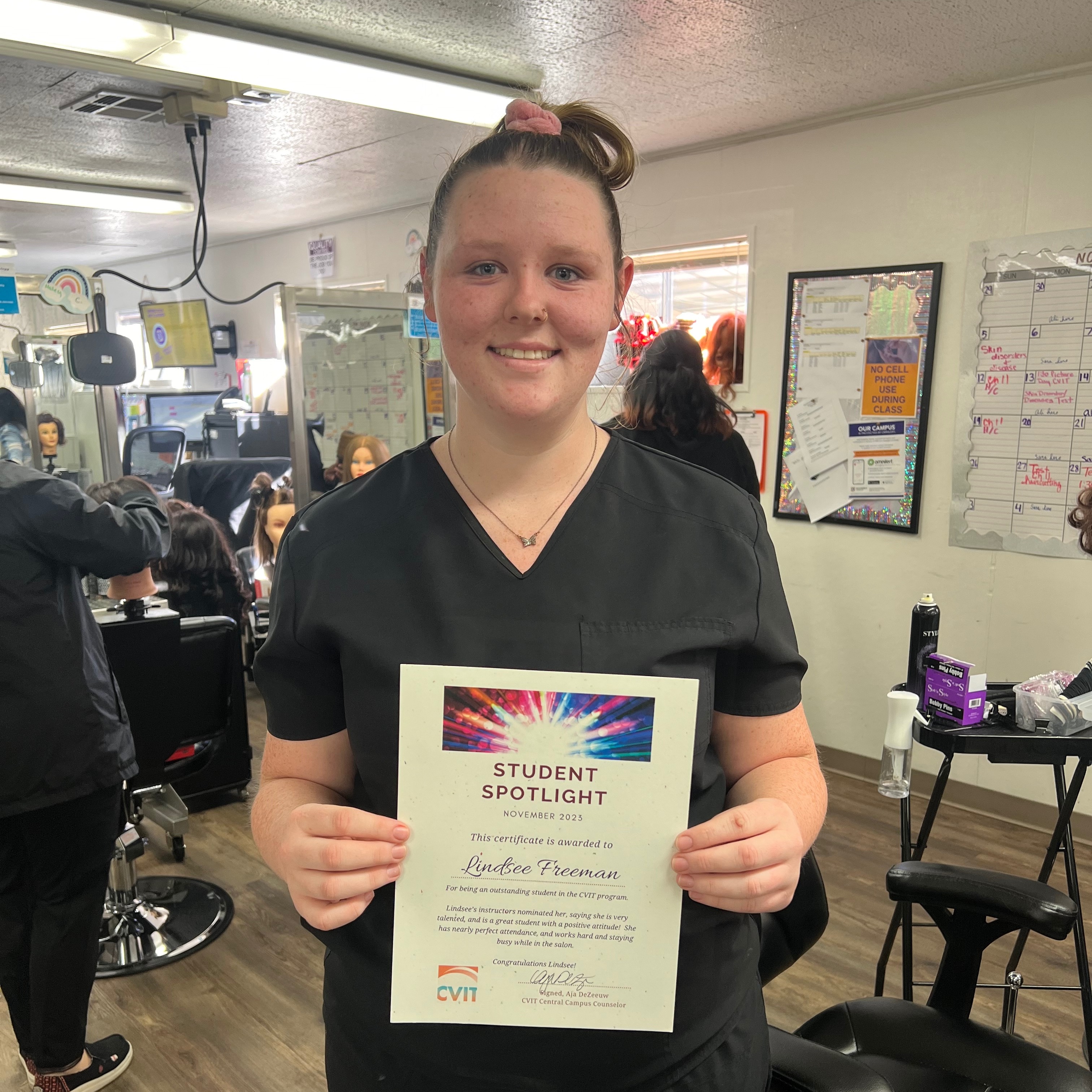 Cosmetology student holding certificate
