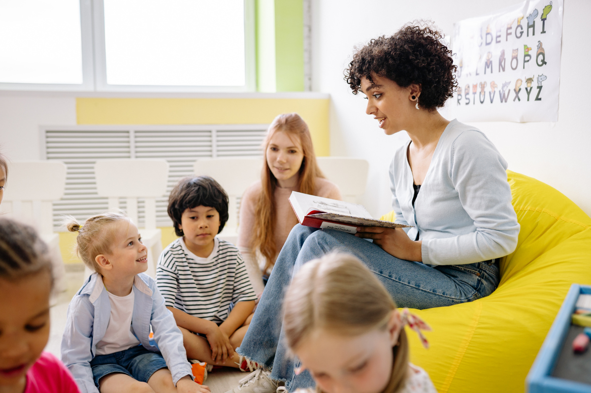 child care teacher reading a story