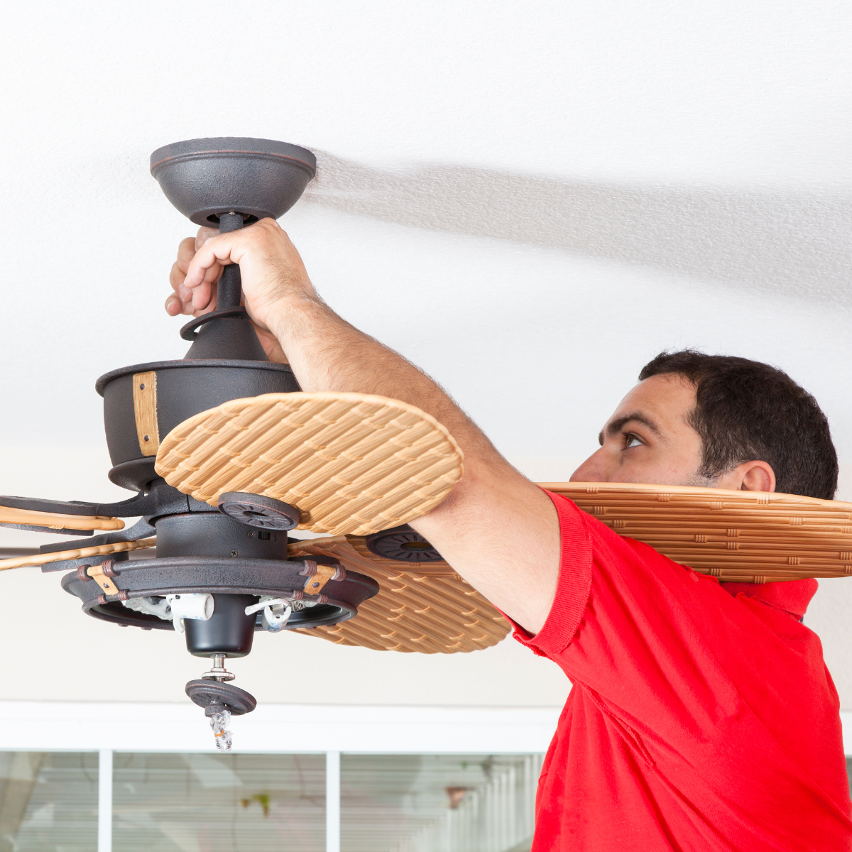 student installing ceiling fan
