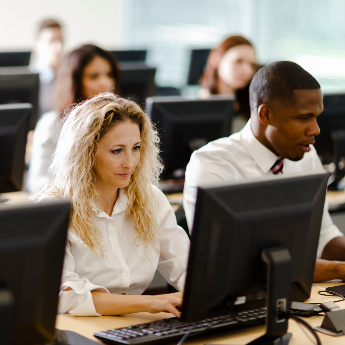 female student in computer class looking at screen