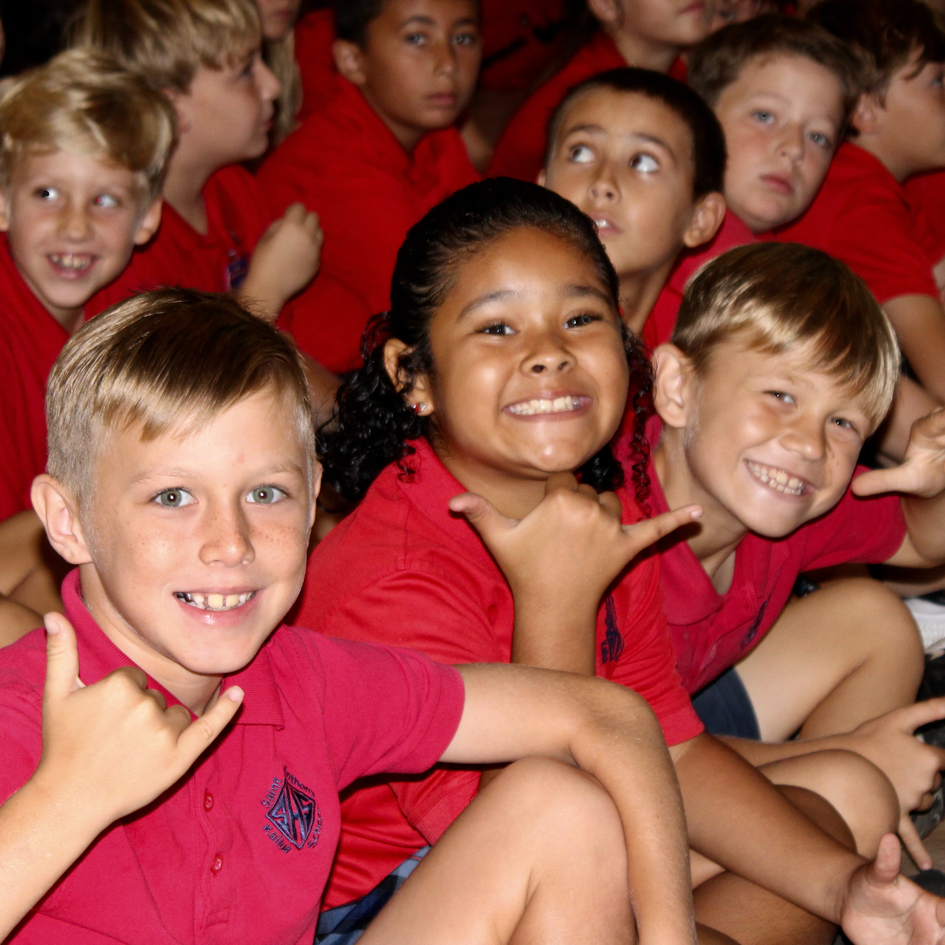 Students smiling during school assembly