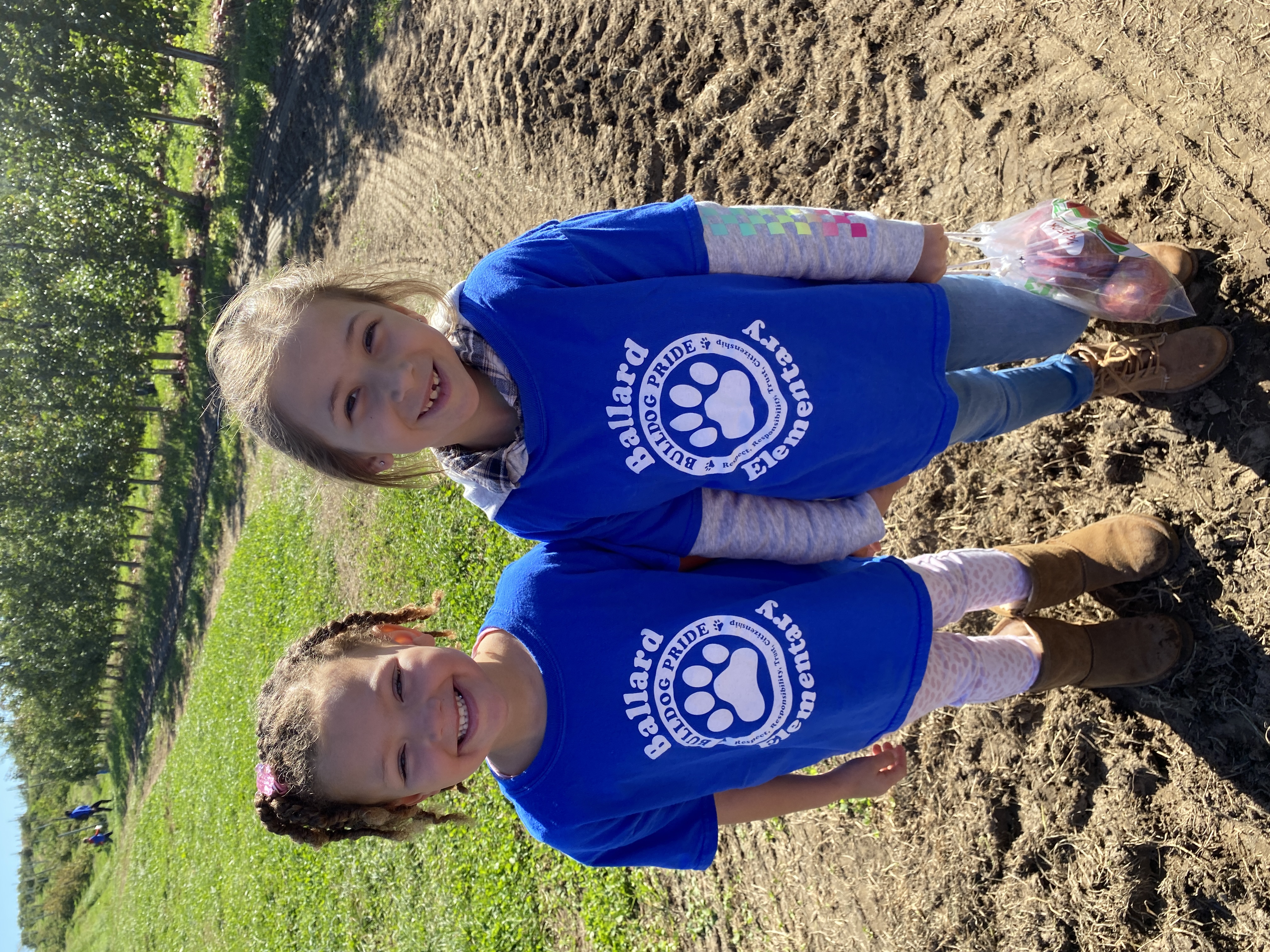 Two children standing in blue Ballard Elementary t-shirts