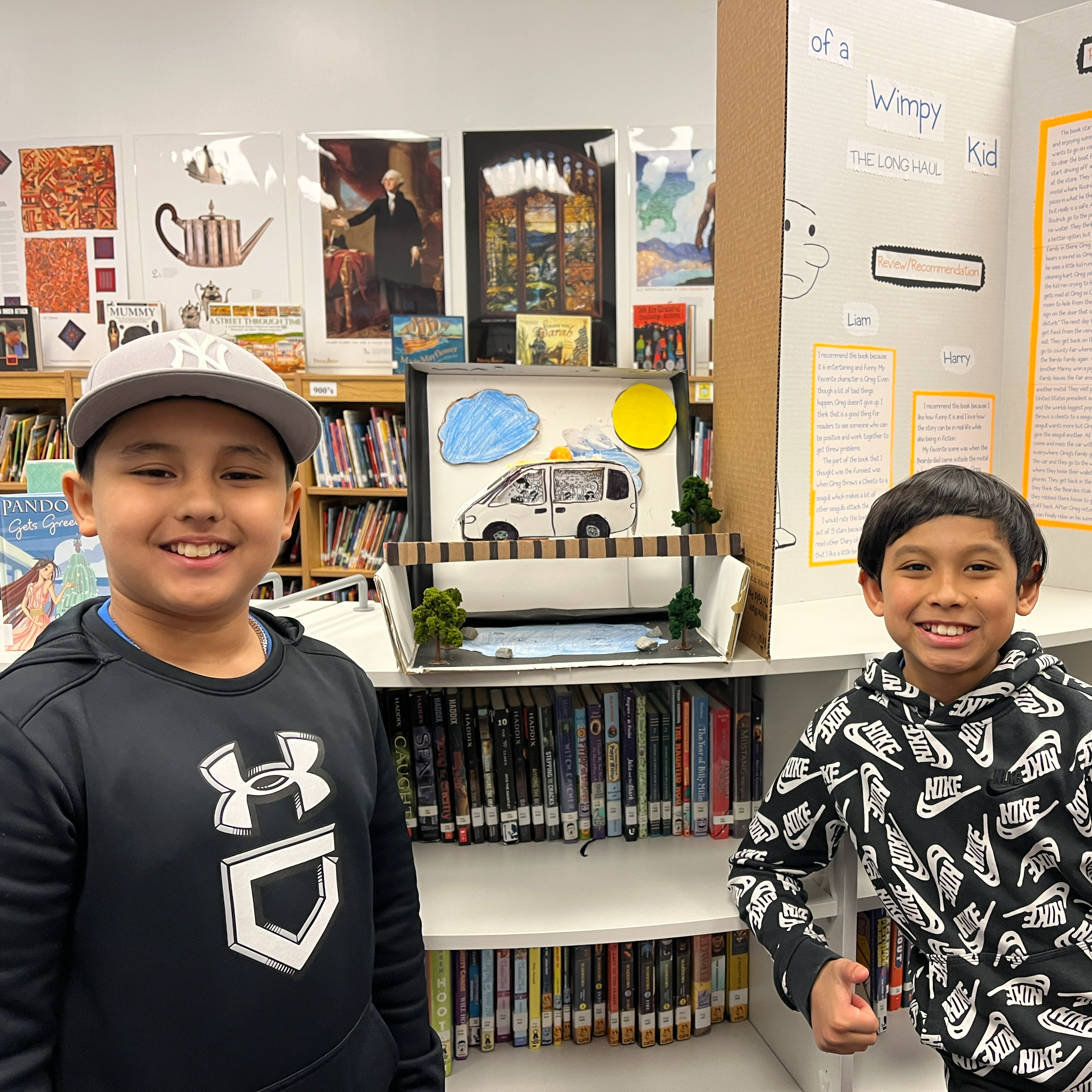 Two students show off their work