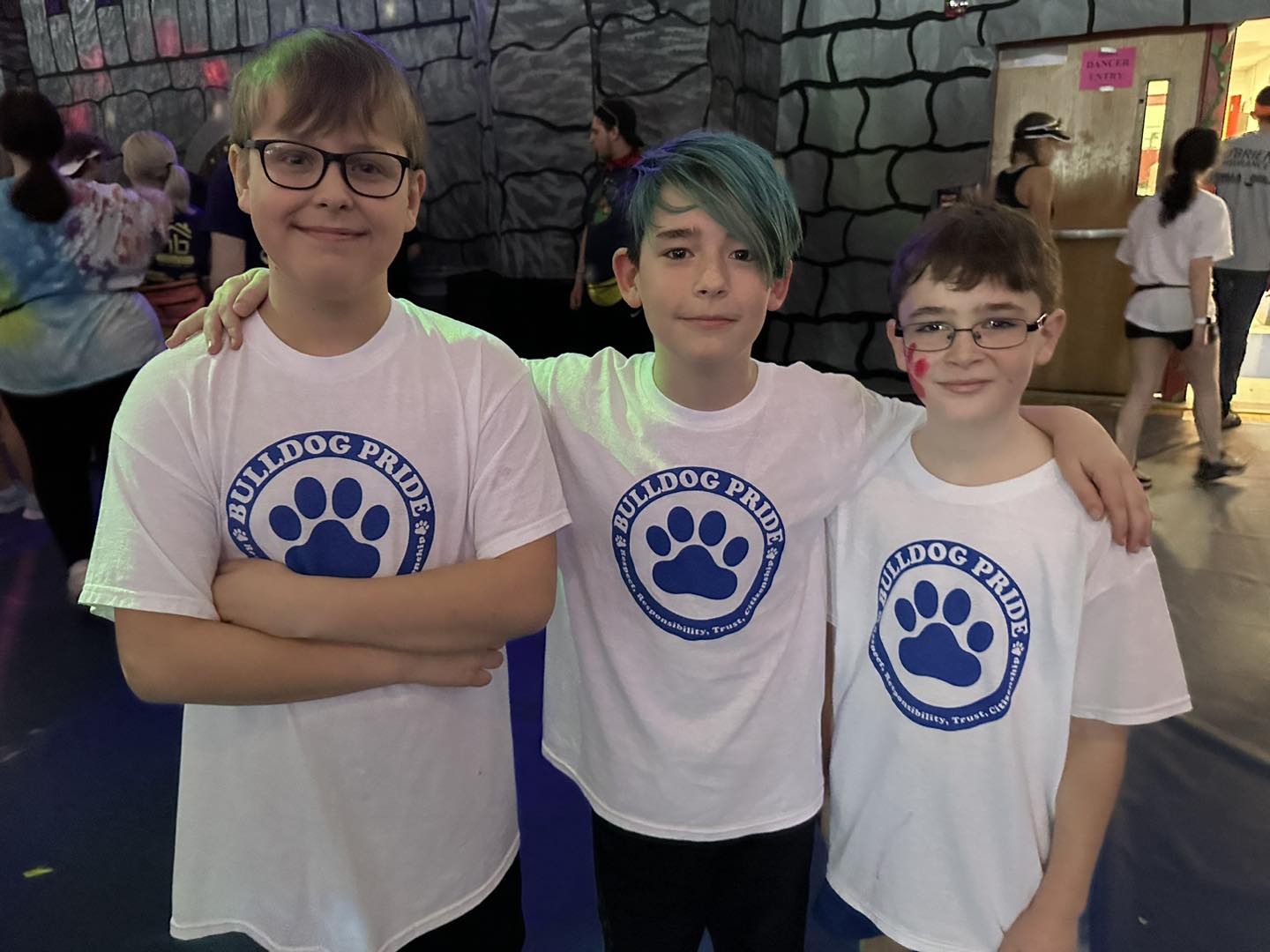 Three fifth graders stand with their white Tanglewood shirts