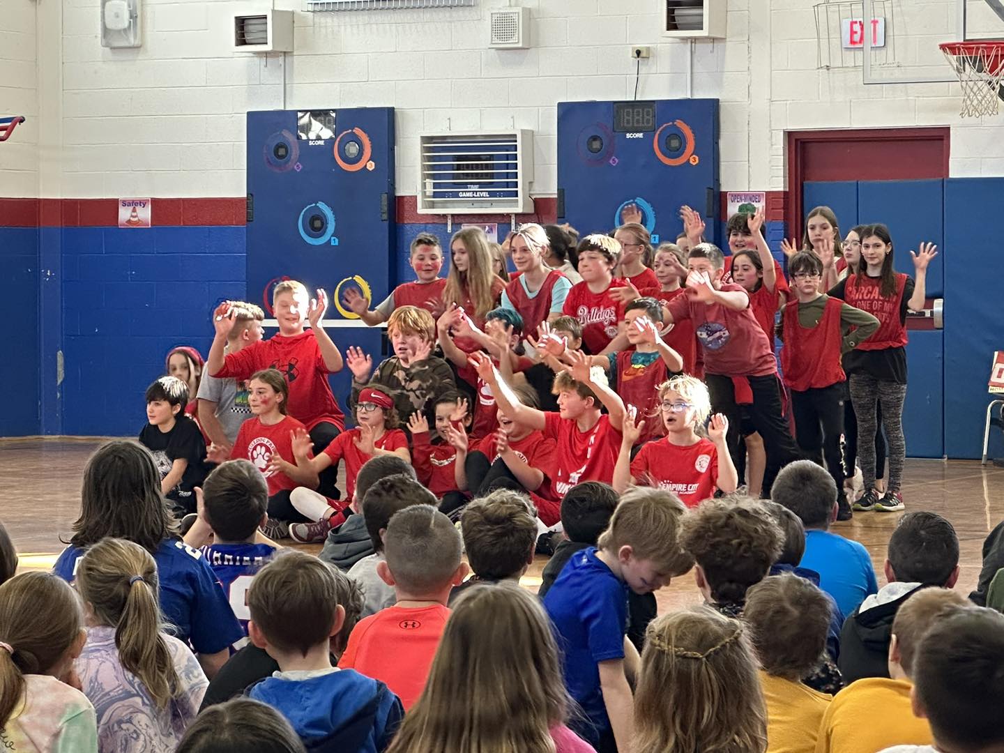 Students in red tee shirts perform a dance.