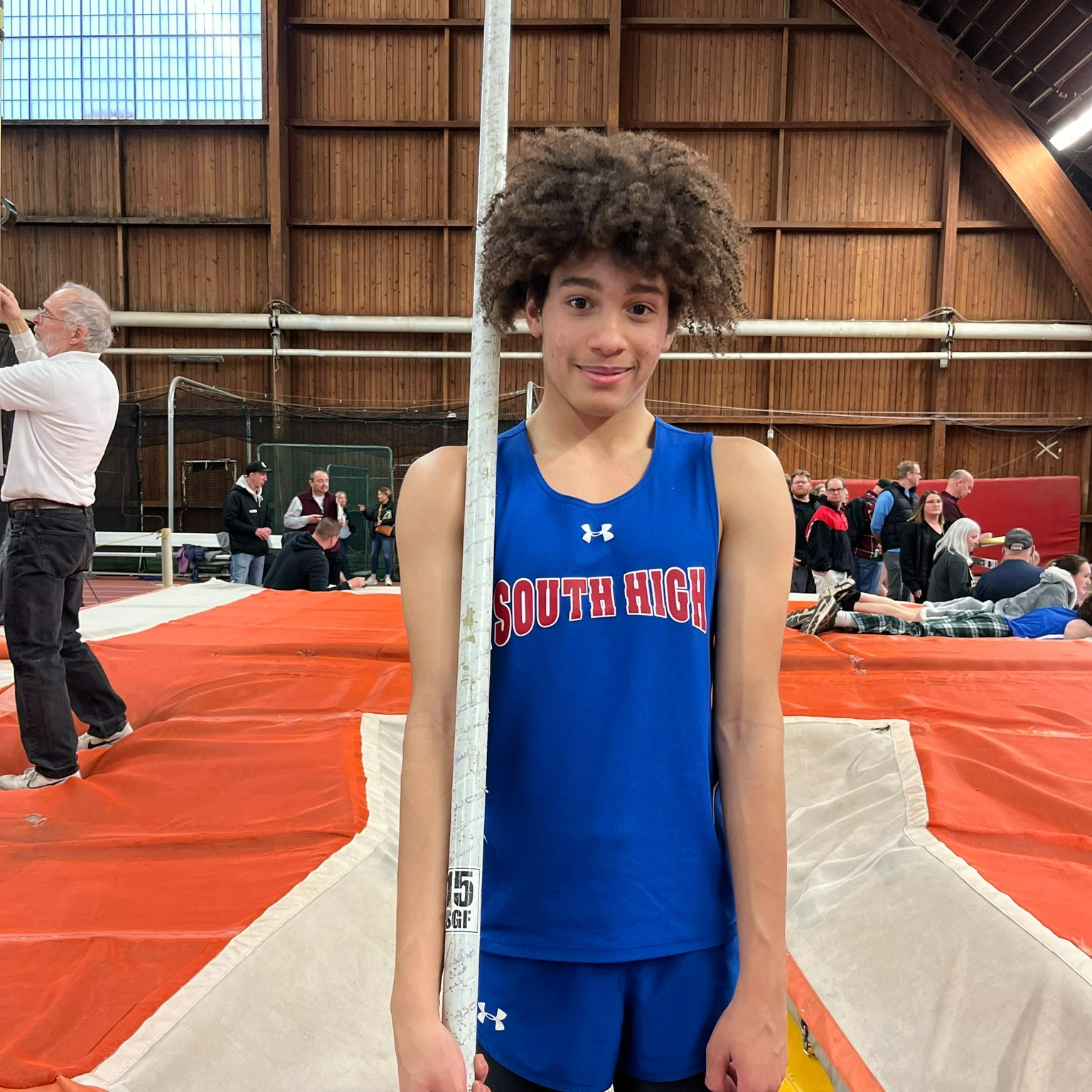 Xavier Johnson stands with his vaulting pole