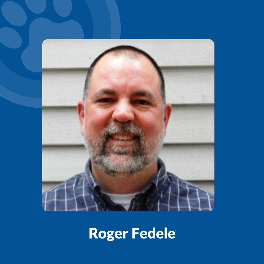 Roger Fedele stands against light colored siding