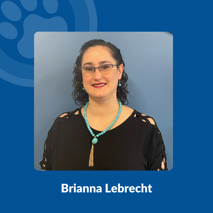 Brianna Lebrecht stands against a blue wall