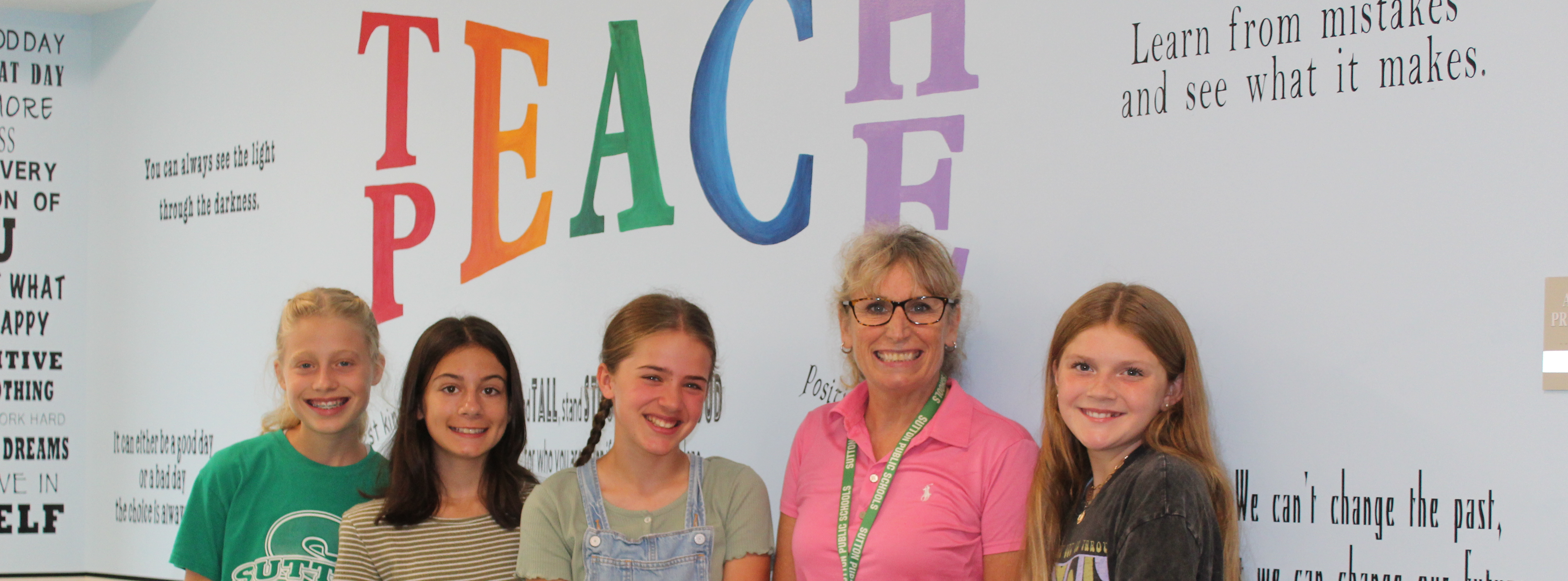 Teachers with sign, Teach Peace