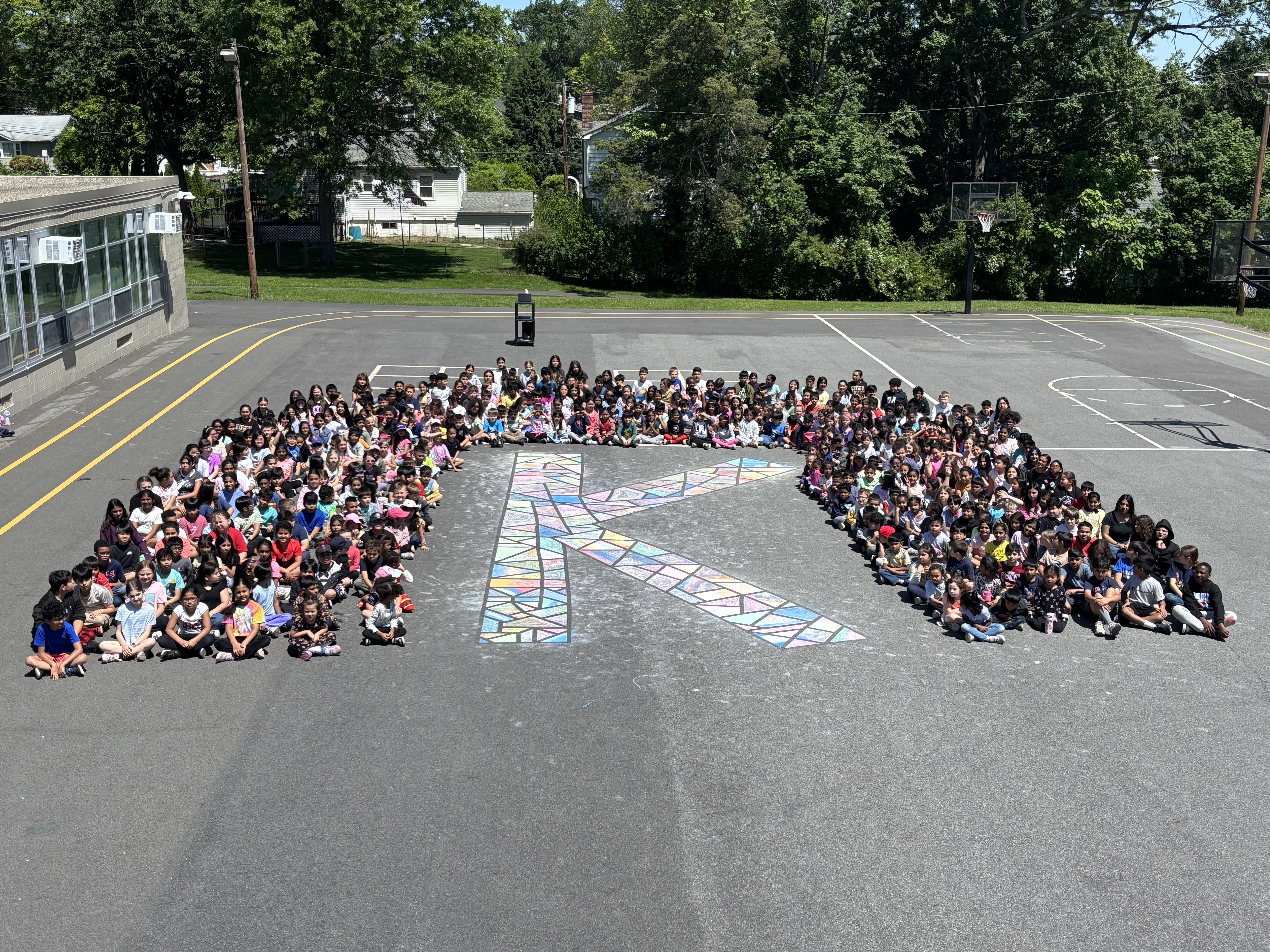 Children sitting around a K