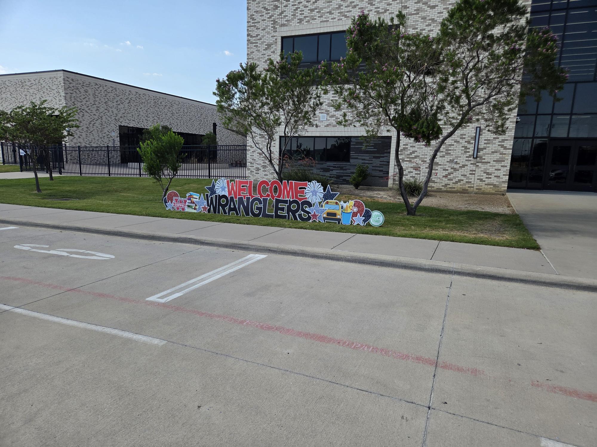 Welcome Back Wranglers sign in front of building