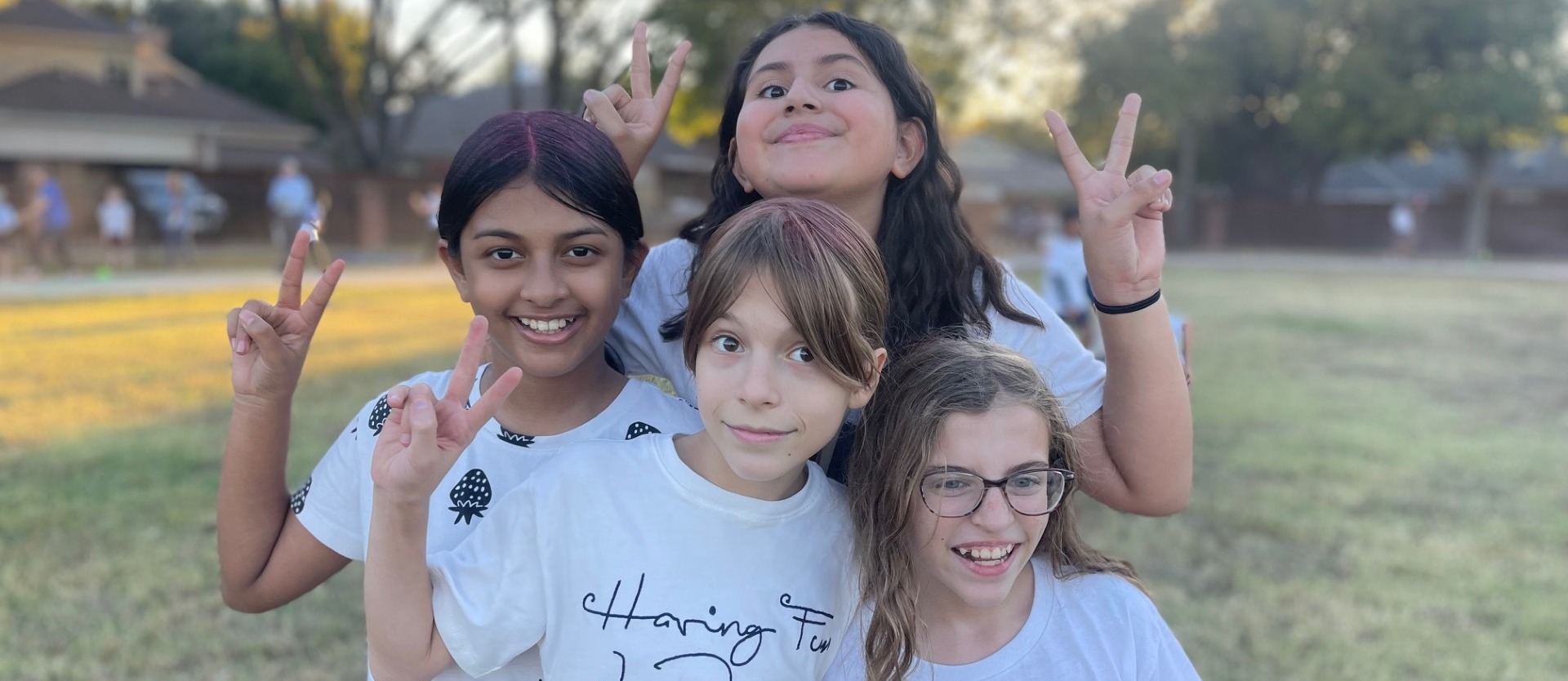 four girls, peace sign